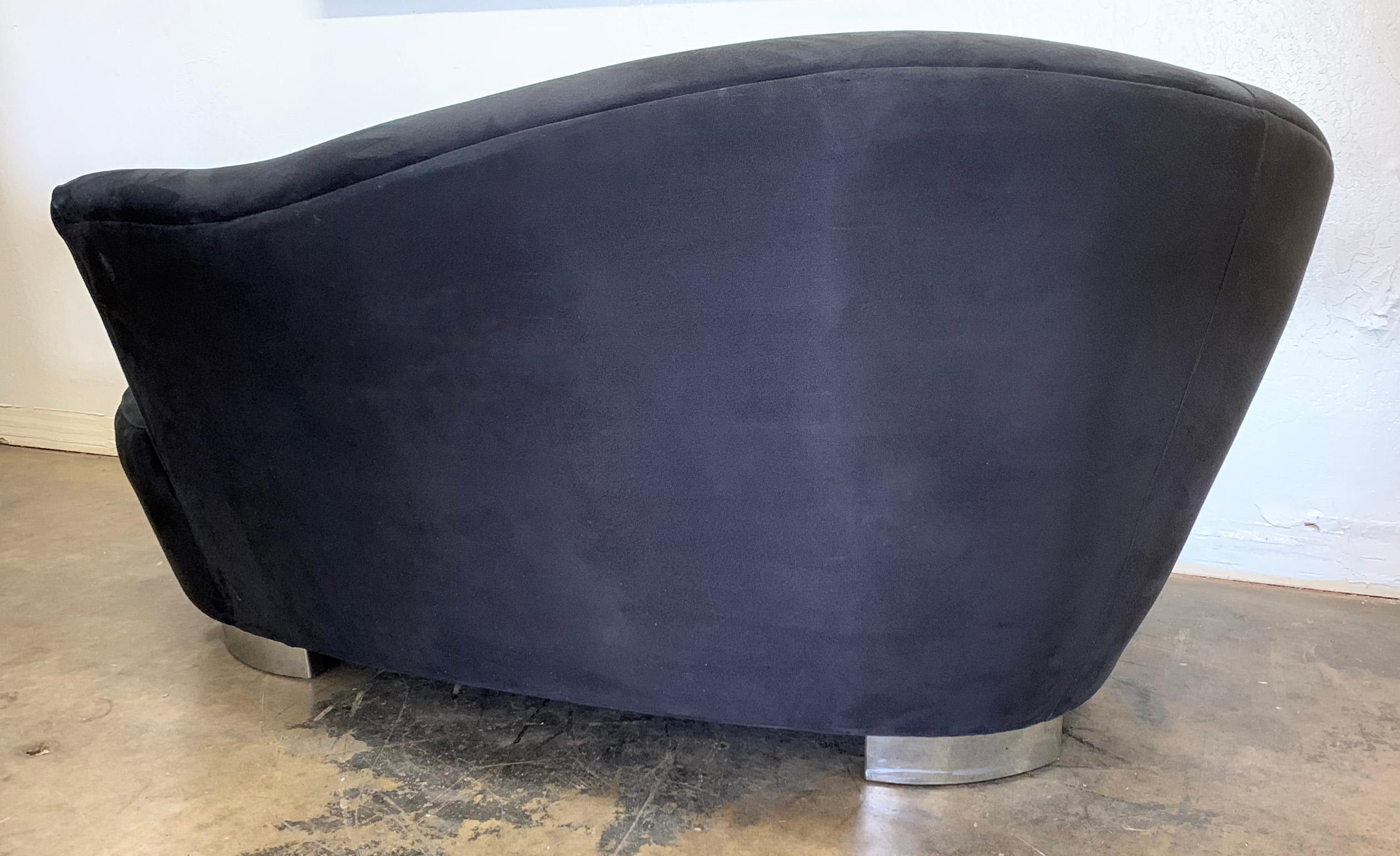 An absolutely stunning petite cloud sofa by Vladimir Kagan. This cloud sofa features Kagan's Classic biomorphic shape with the chrome teeth feet that give it a floating effect as if it were a cloud.

The upholstery on this piece is a black