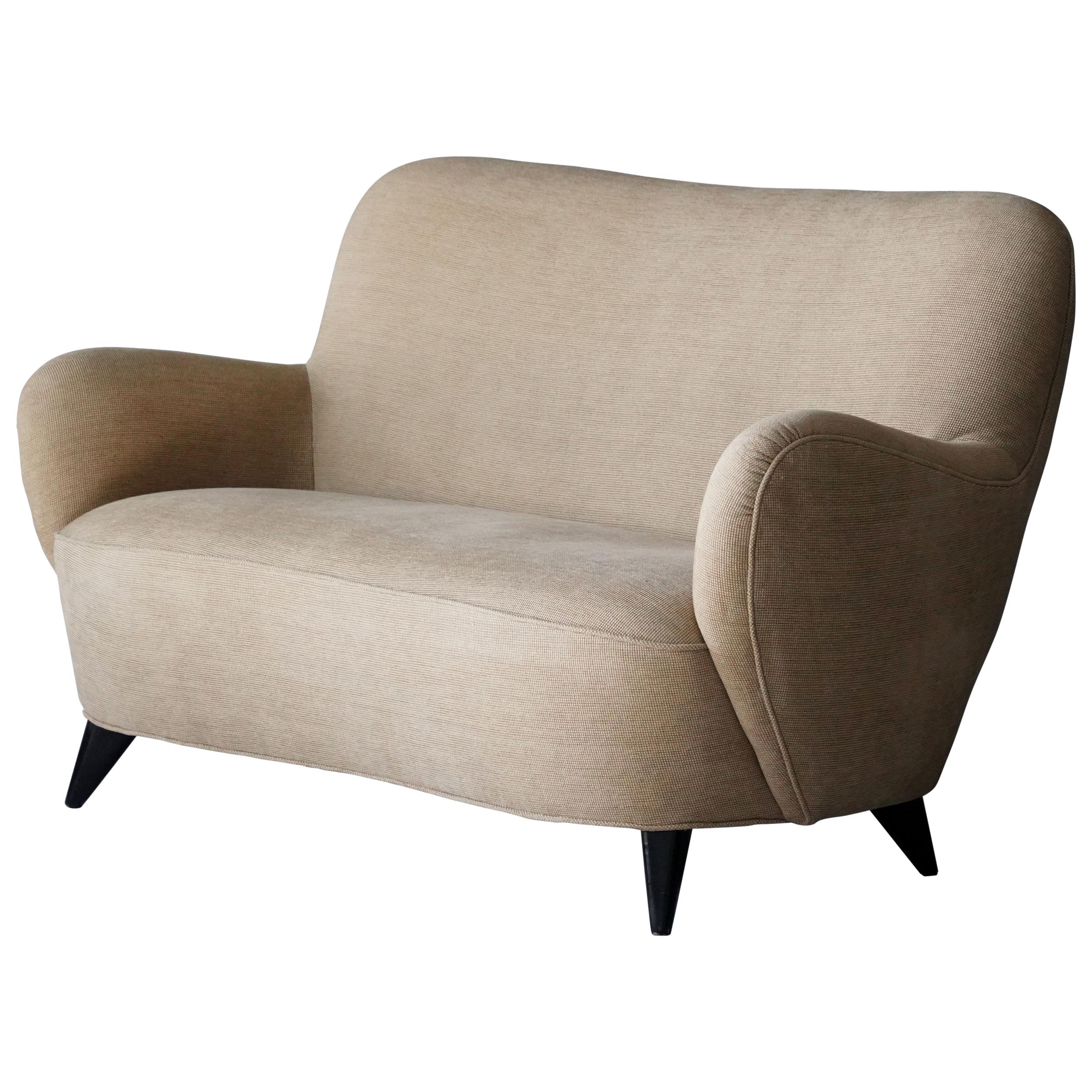 A settee / sofa, designed by Vladimir Kagan in 1947 and made by Kagan-Dreyfuss, Inc in the 1950s. The soft organic form rests on four tapered walnut legs. 

Other designers of the period include Jean Royère, Gio Ponti, Isamu Noguchi, and Edward