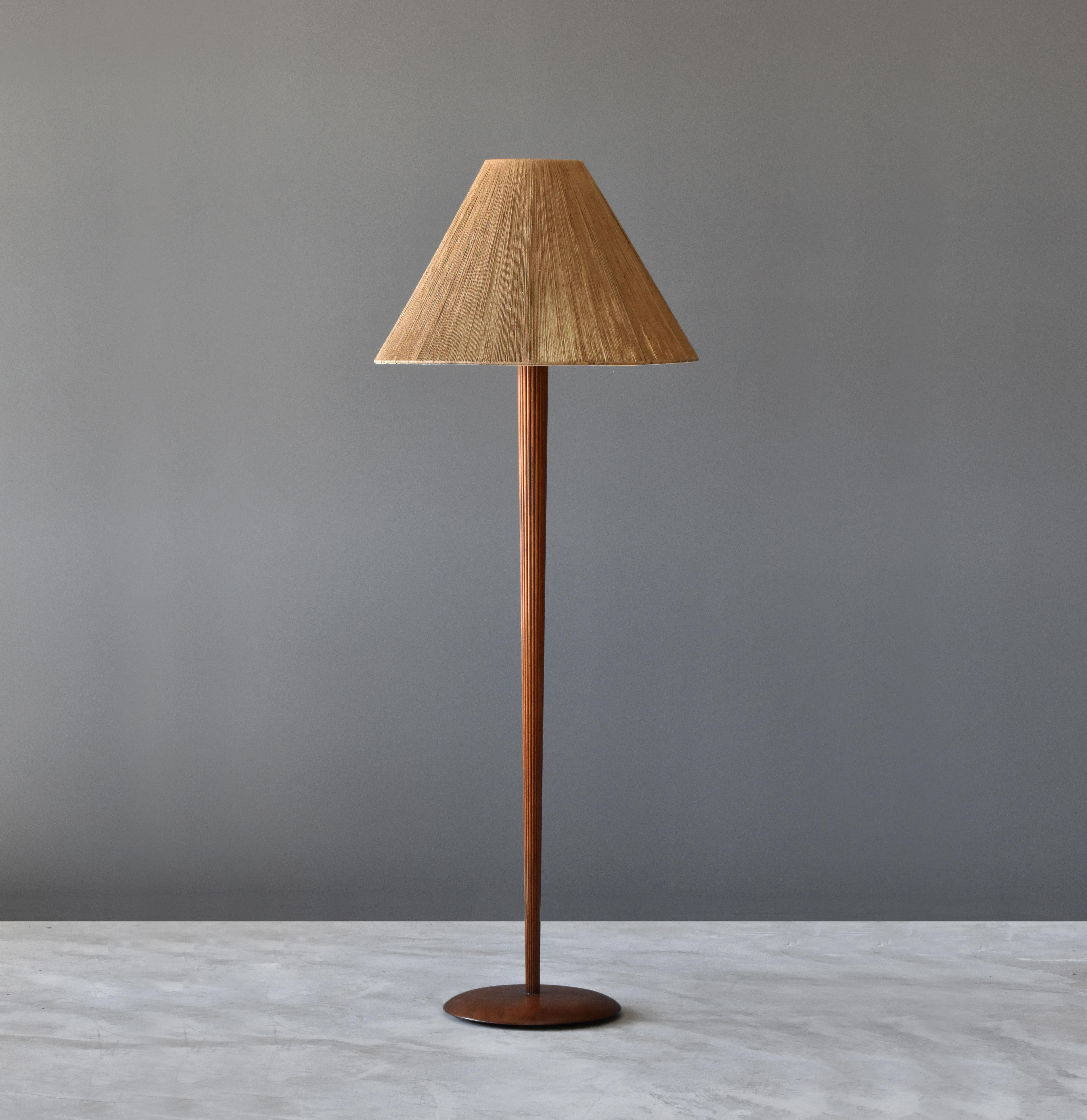 A rare or possibly unique floor lamp designed by Vladimir Kagan. Produced by Kagan-Dreyfus in New York circa 1960s. 

Rod and base is finely carved walnut. Bears its original oversized string shade. 

Other American designers of the era include