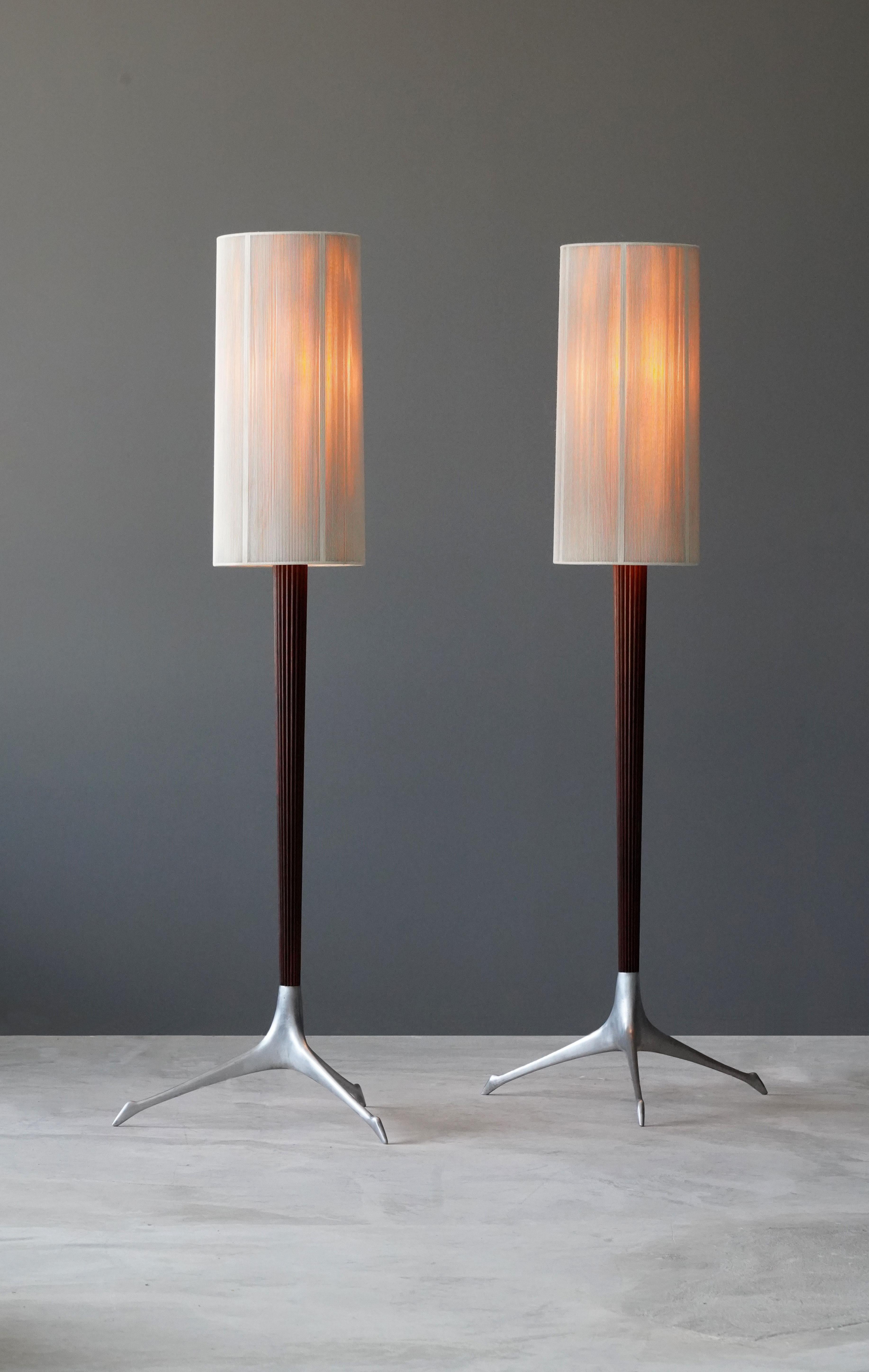 A pair of rare floor lamps, designed by Vladimir Kagan and produced by Kagan-Dreyfus Inc, circa 1958. Cast aluminum is paired with a finely carved mahogany rod, bears original nylon screens. 

Other American designers of the period include George