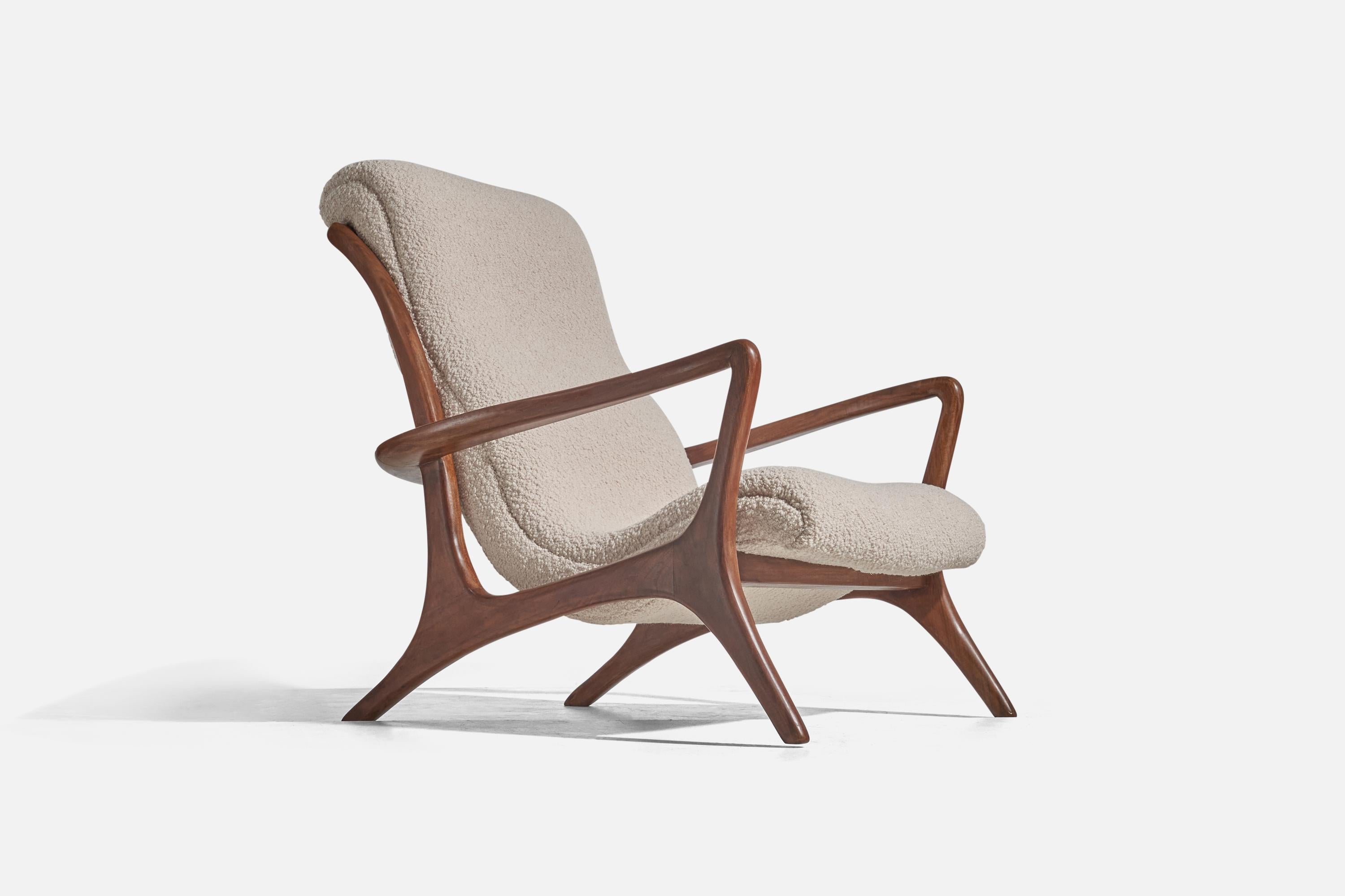 A rare lounge lounge chair designed by Vladimir Kagan for his own firm Vladimir Kagans Design. Designed c. 1950s, this example produced c. 1970.

Features finely carved walnut, reupholstered in a brand-new high-end bouclé fabric.

