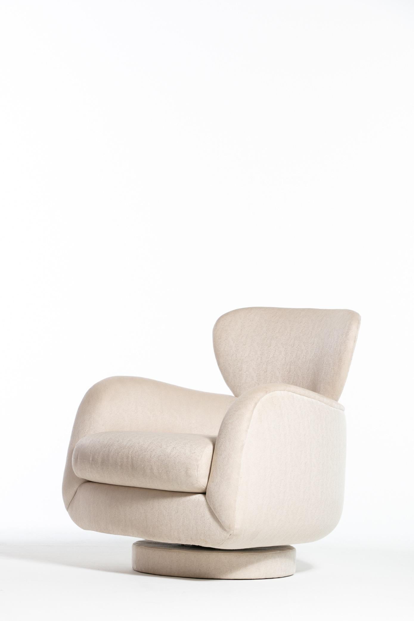 Vintage Vladimir Kagan swivel / rocking armchair for Directional, with label. Sculptural, sensual form from Vladimir Kagan. This chair not only swivels but also has a rocking feature, making it a very comfortable seating choice.