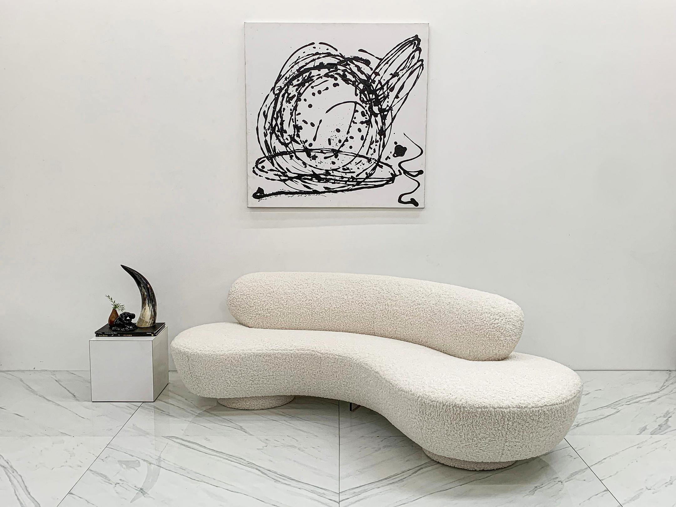 This Vladimir Kagan sofa is simply stunning. The entire sofa has been upholstered in a heavy ivory bouclé, including the double disc bottom. This heavily textured sofa is not only visually appealing, it's insanely comfortable and is incredibly
