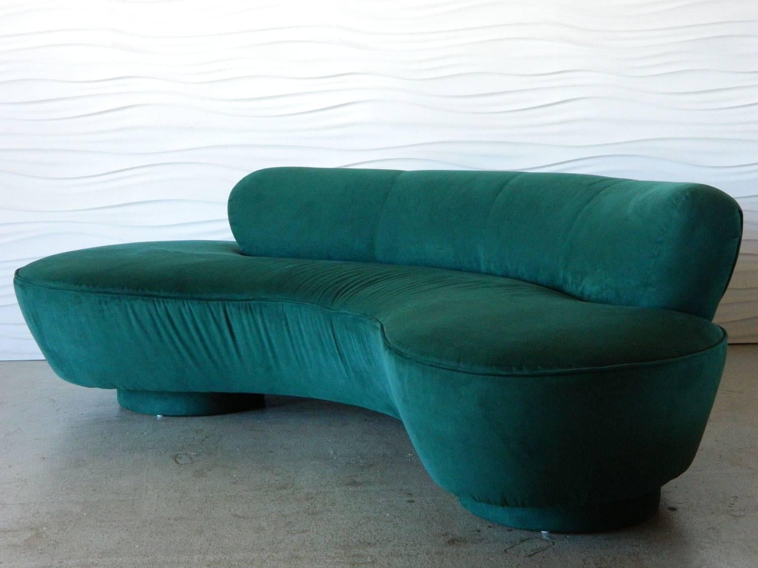 An iconic Vladimir Kagan design, this Serpentine sofa sits on two round, upholstered bases and centered Lucite support. 

Given the biomorphic shape of this sofa.