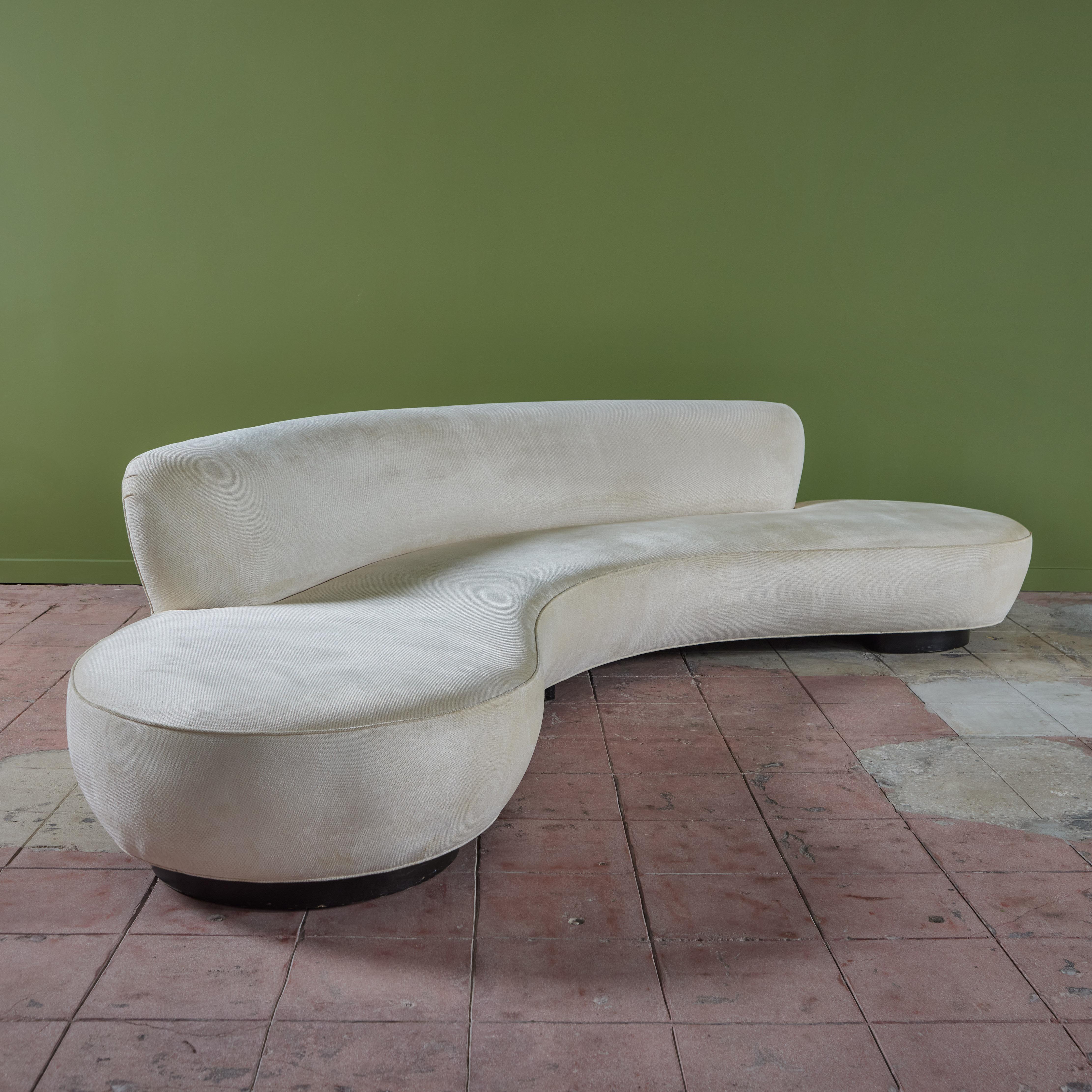 Curved 'model 150BS' sofa by Vladimir Kagan, c.2000s, USA. Vladimir Kagan (1927-2016) originally designed this sofa in the 1950s, this piece is from a later production. The sofa features the original cream linen velvet upholstery with walnut base.