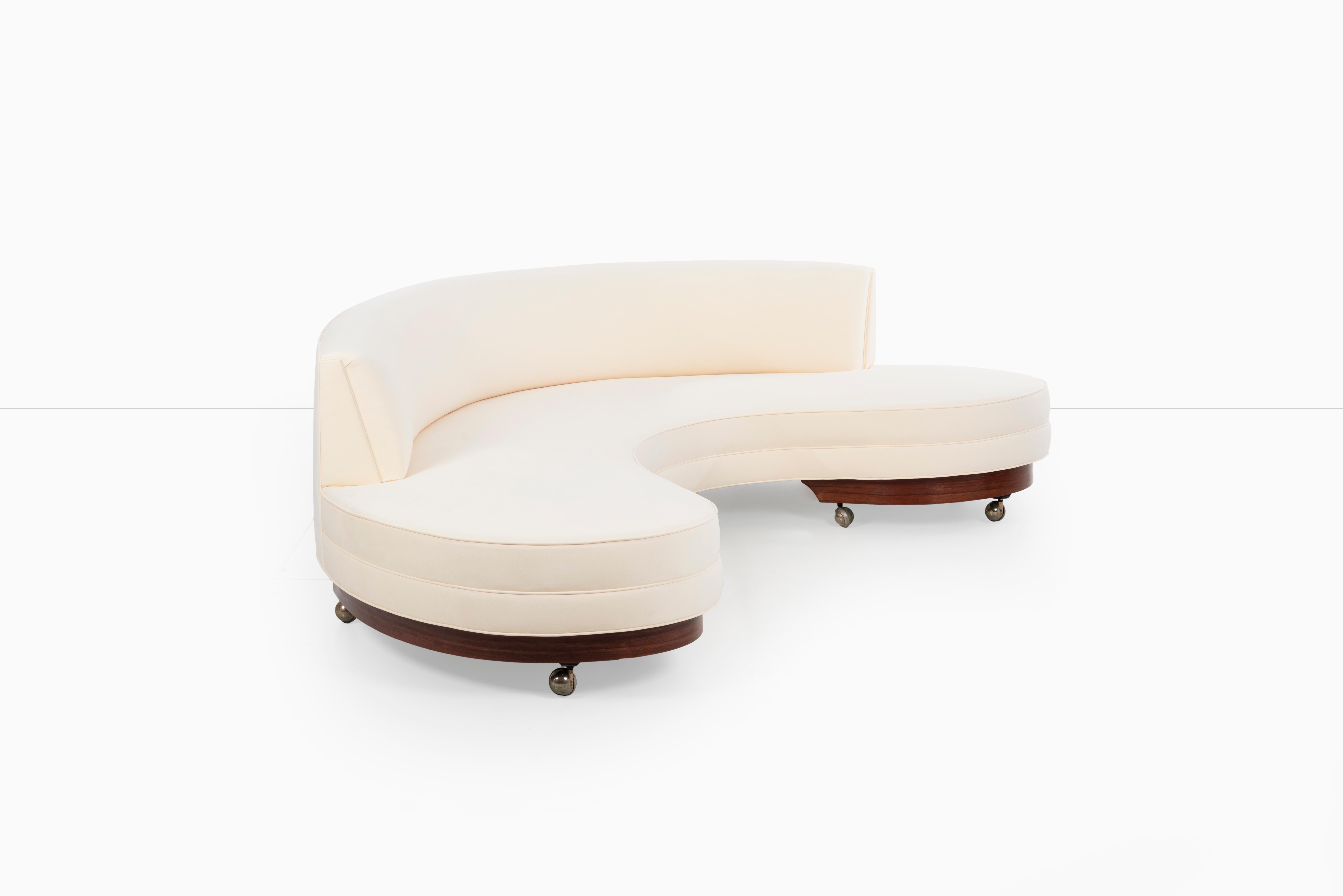 Vladimir Kagan for Kagan-Dreyfuss, Inc. Large Serpentine Sofa:
Completely rebuilt, restored, and reupholstered with Knoll Ultra suede with rosewood base, oiled finish with brass wheels.
About the fabric: Ultrasuede is the premier microfiber in the