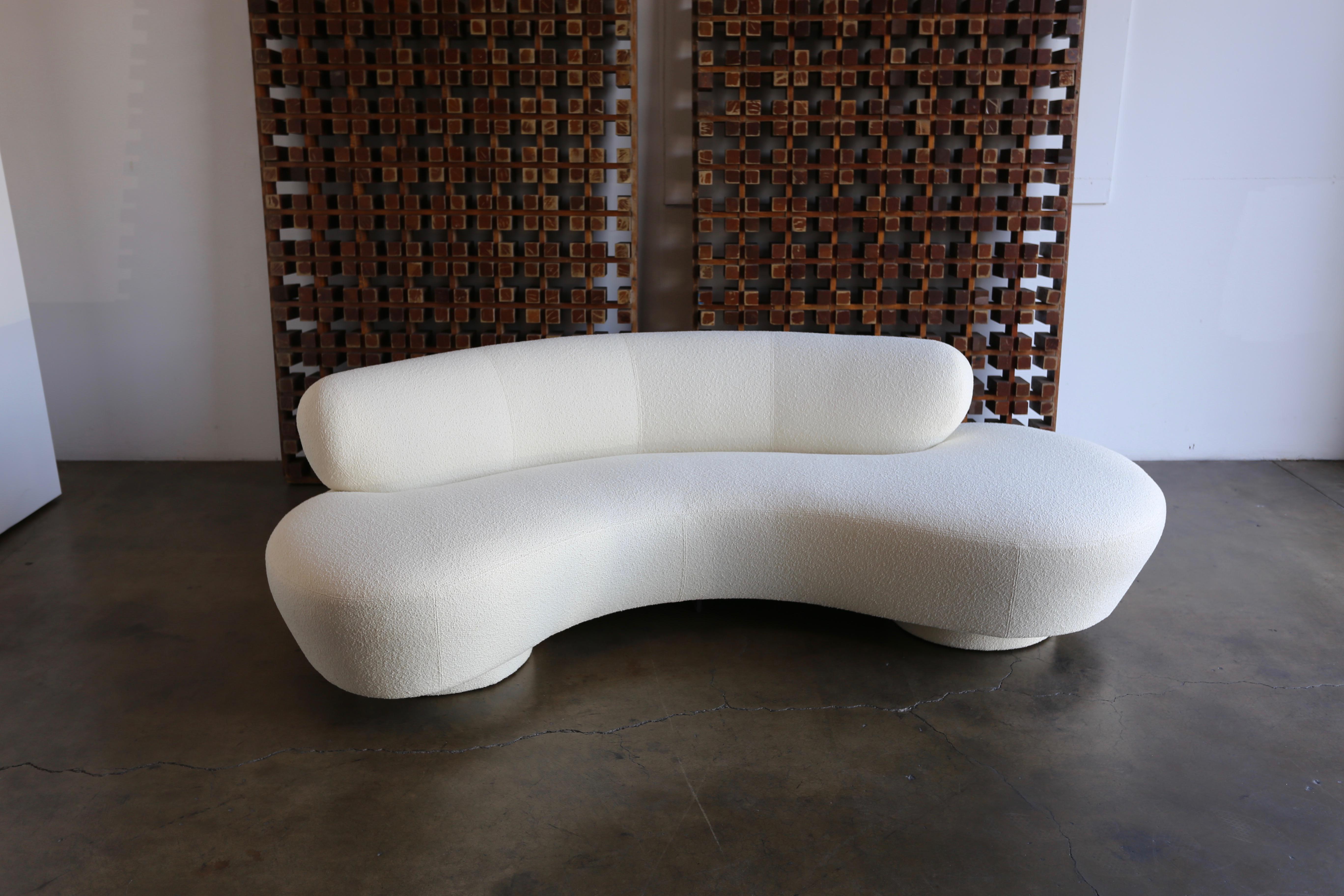 Vladimir Kagan serpentine sofa for Directional. This piece has been upholstered in Knoll Classic Boucle. A iconic freeform curved sofa design.