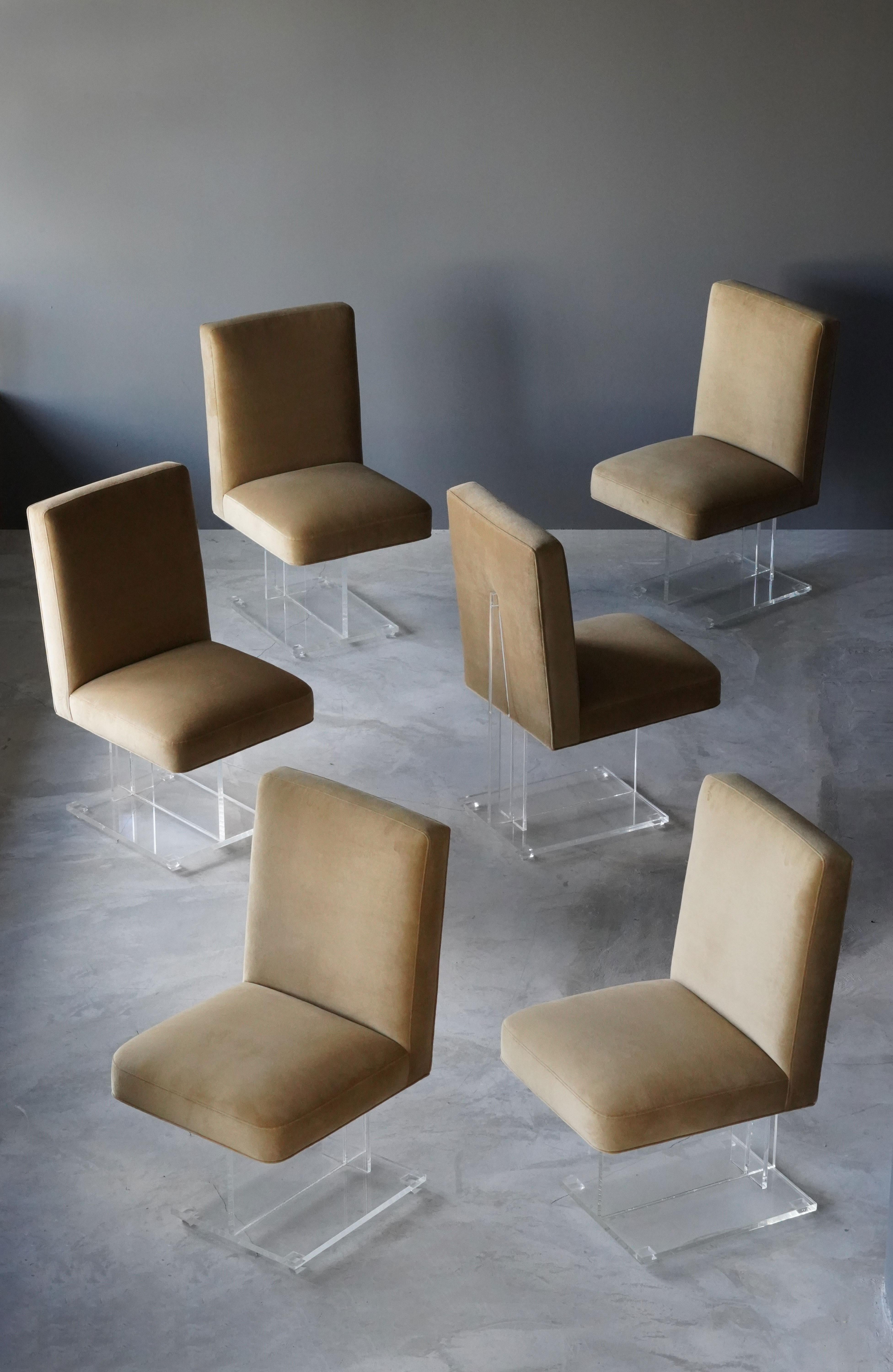 A set if 6 dining / side chairs, model 6726 designed by Vladimir Kagan, circa 1970s. The overstuffed seats rests on one-legged Lucite bases. 

Other designers of the period include Karl Springer, Paul Evans, Charles Hollis Jones, Edward Wormley,