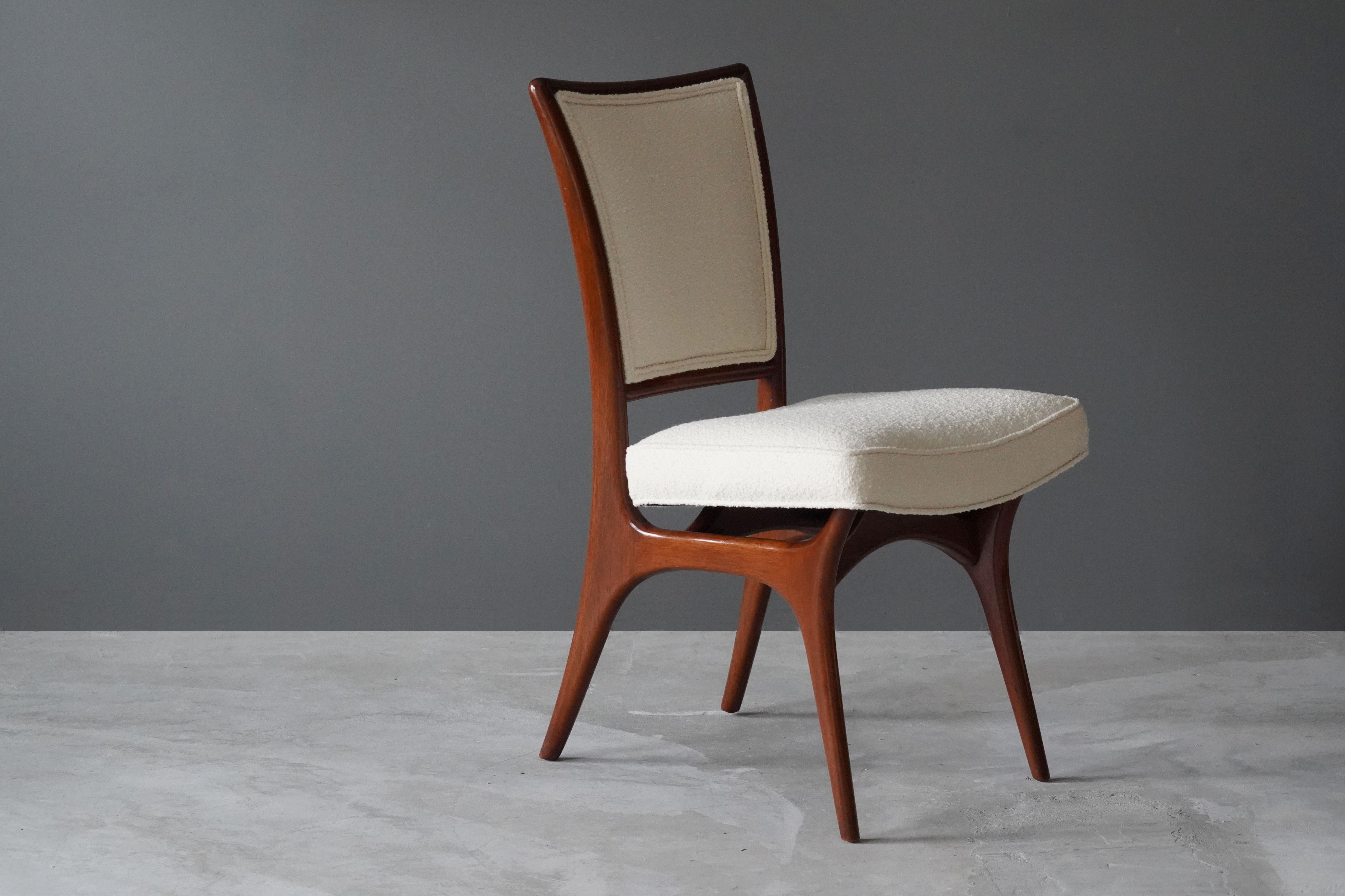 A sculptural organic side chair or dining chair designed by Vladimir Kagan. Organicly carved walnut is paired with a high-end boucle fabric. Marked.