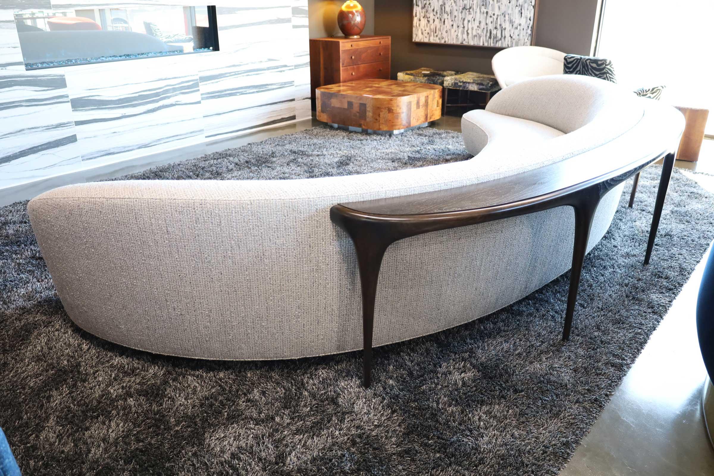 Beautiful custom made Vladimir Kagan Sloane sofa. Sofa measures 12' wide. Includes sculpted sofa table with four legs that attaches to the back of the sofa. Beautifully upholstered in a Holly Hunt great Plains fabric.