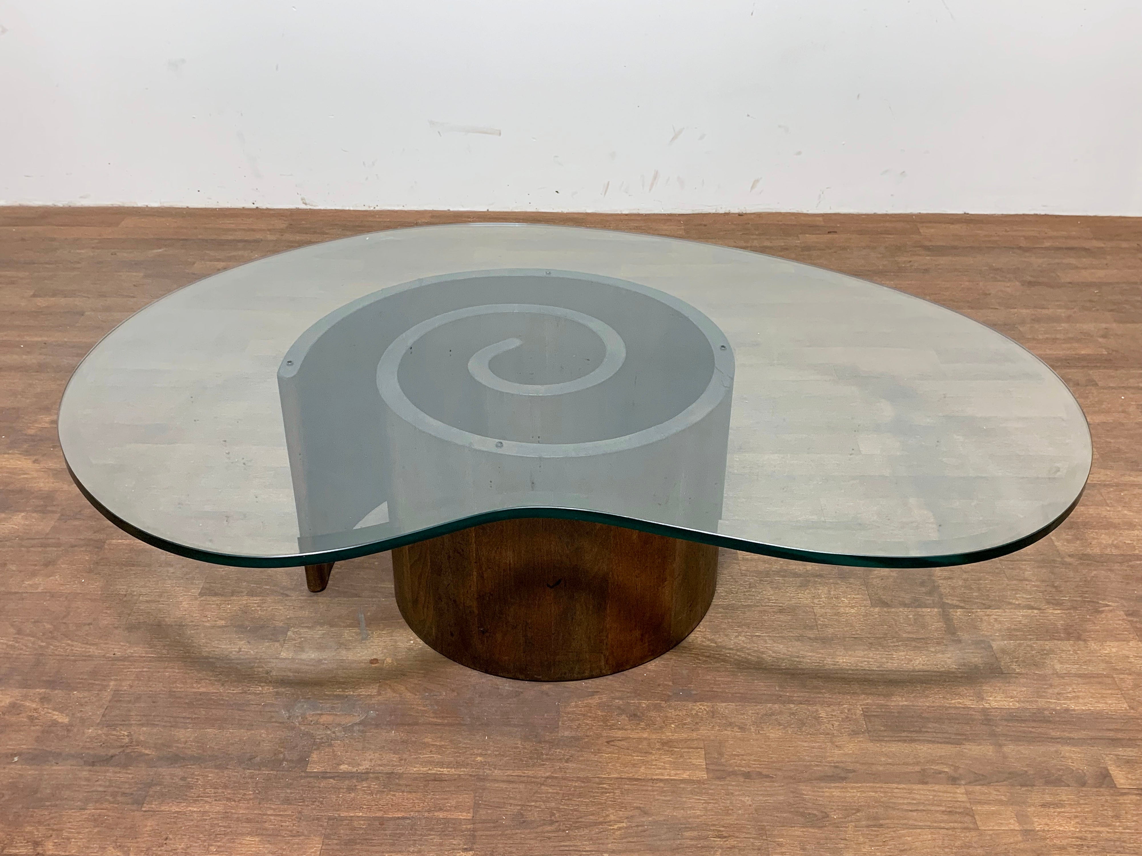Original Vladimir Kagan “snail” coffee table in spiral formed walnut paired with a boomerang shaped glass top, circa 1960s. Please note the glass top is not original to the table.