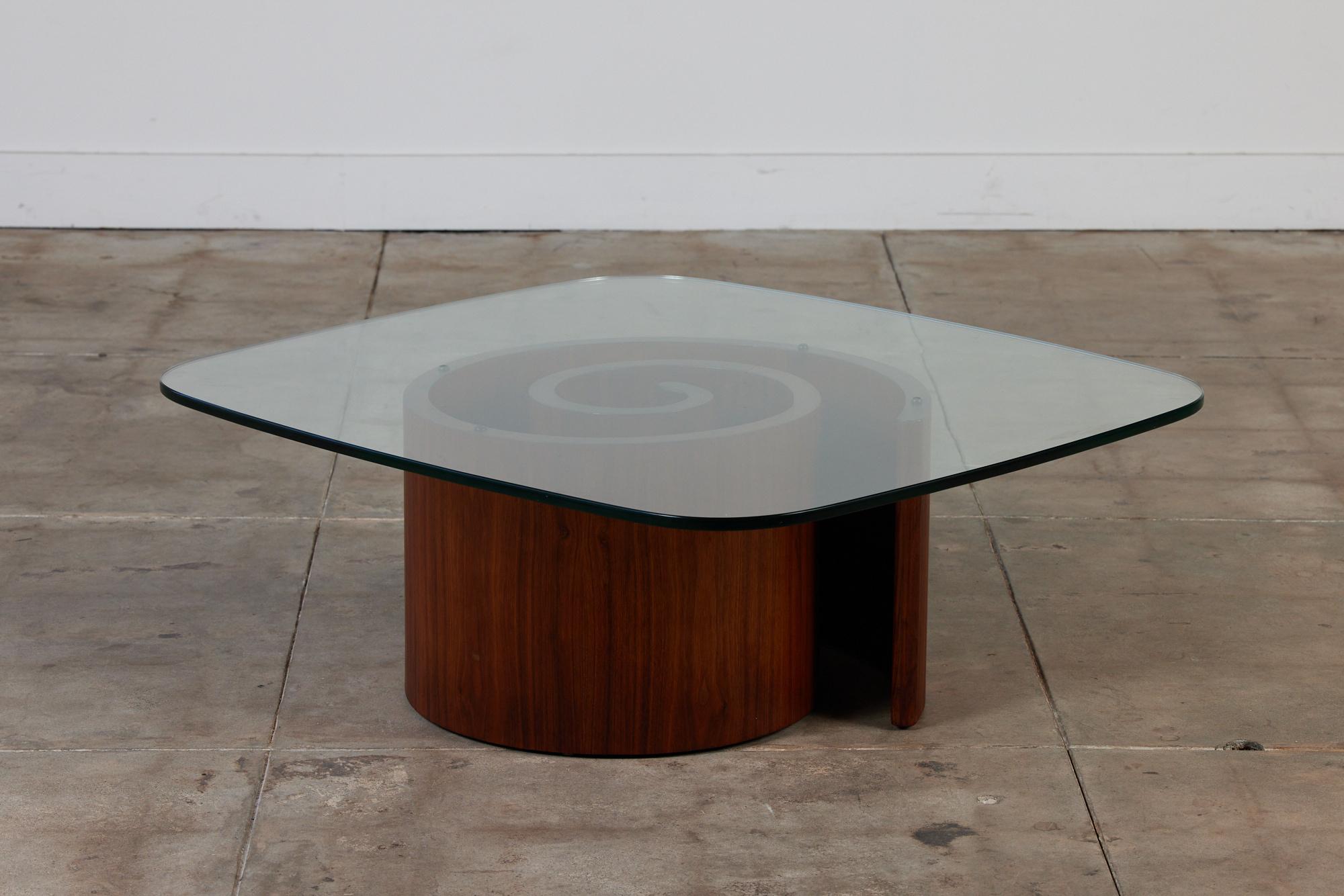 The iconic Snail coffee table by Vladimir Kagan, c.1960s, USA, is comprised of a bent walnut base in a spiral shape. A top the base rests the original glass top, with rounded edges. Visually this sculptural table will add a bit of playfulness to