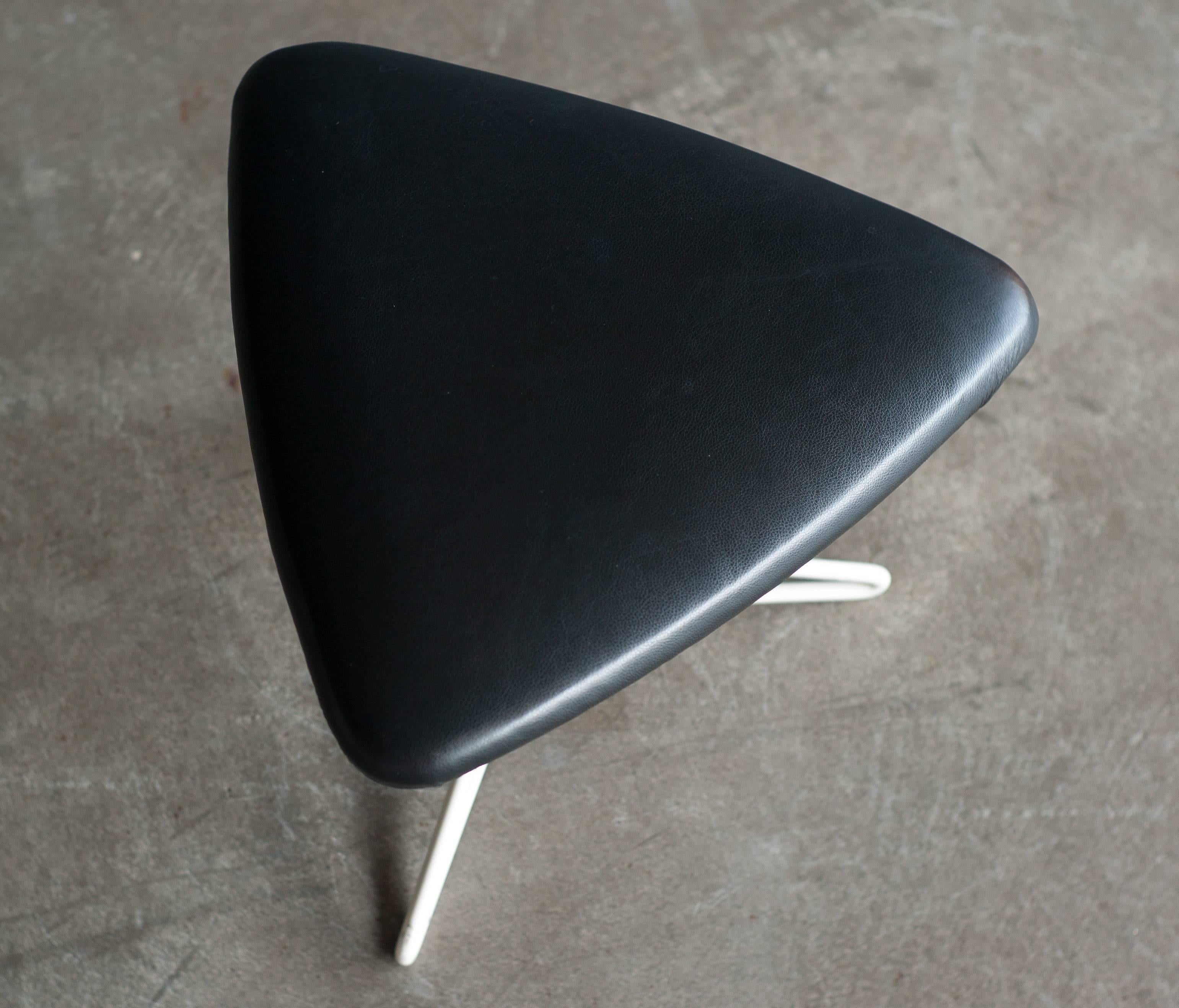 A beautiful stool by Vladimir Kagan in black leather with a white enameled steel base.

 
