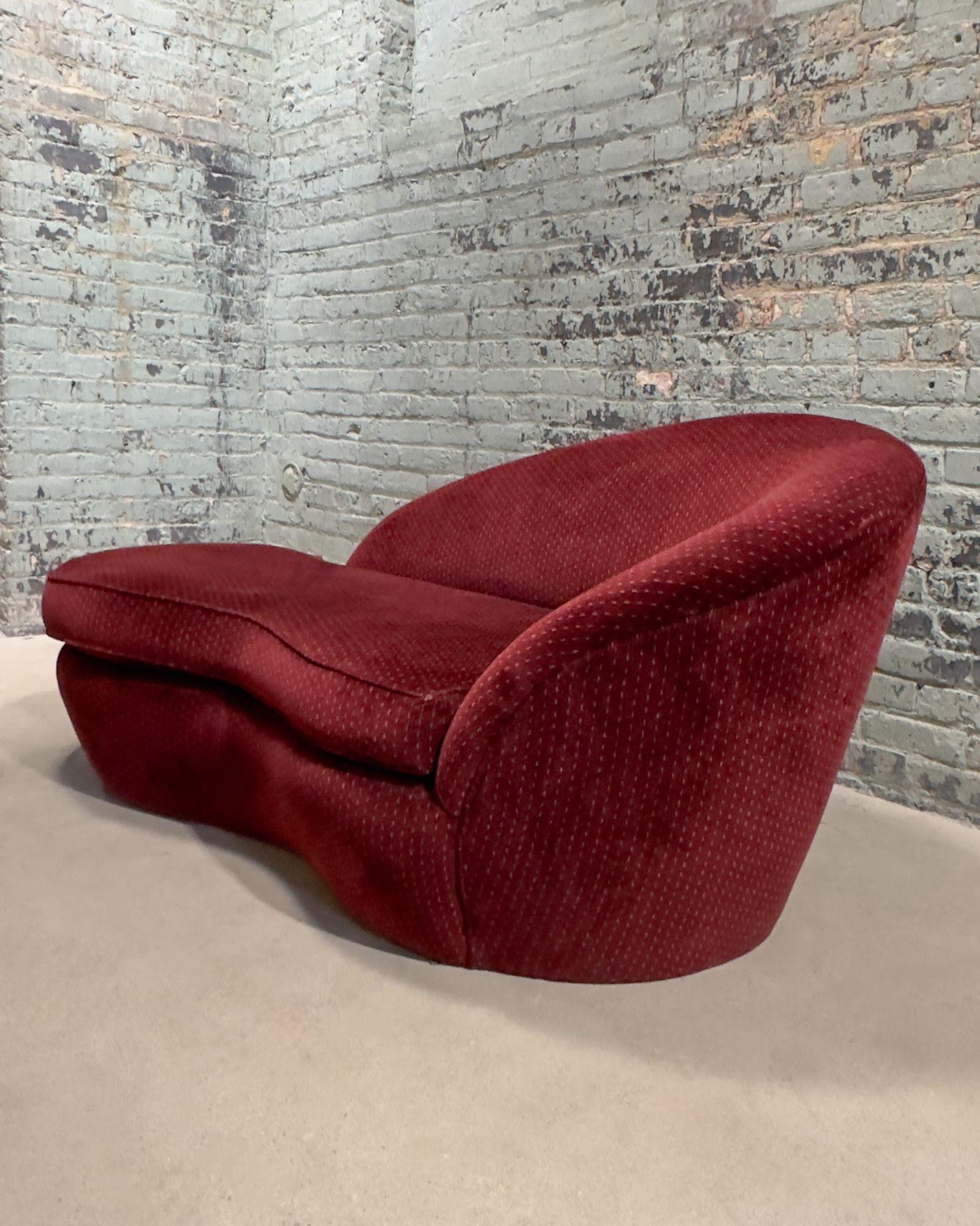 Vladimir Kagan Style Curved Chaise Lounge, 1960's. Original upholstery in a burgundy color, with no rips or tears.
Measures 65