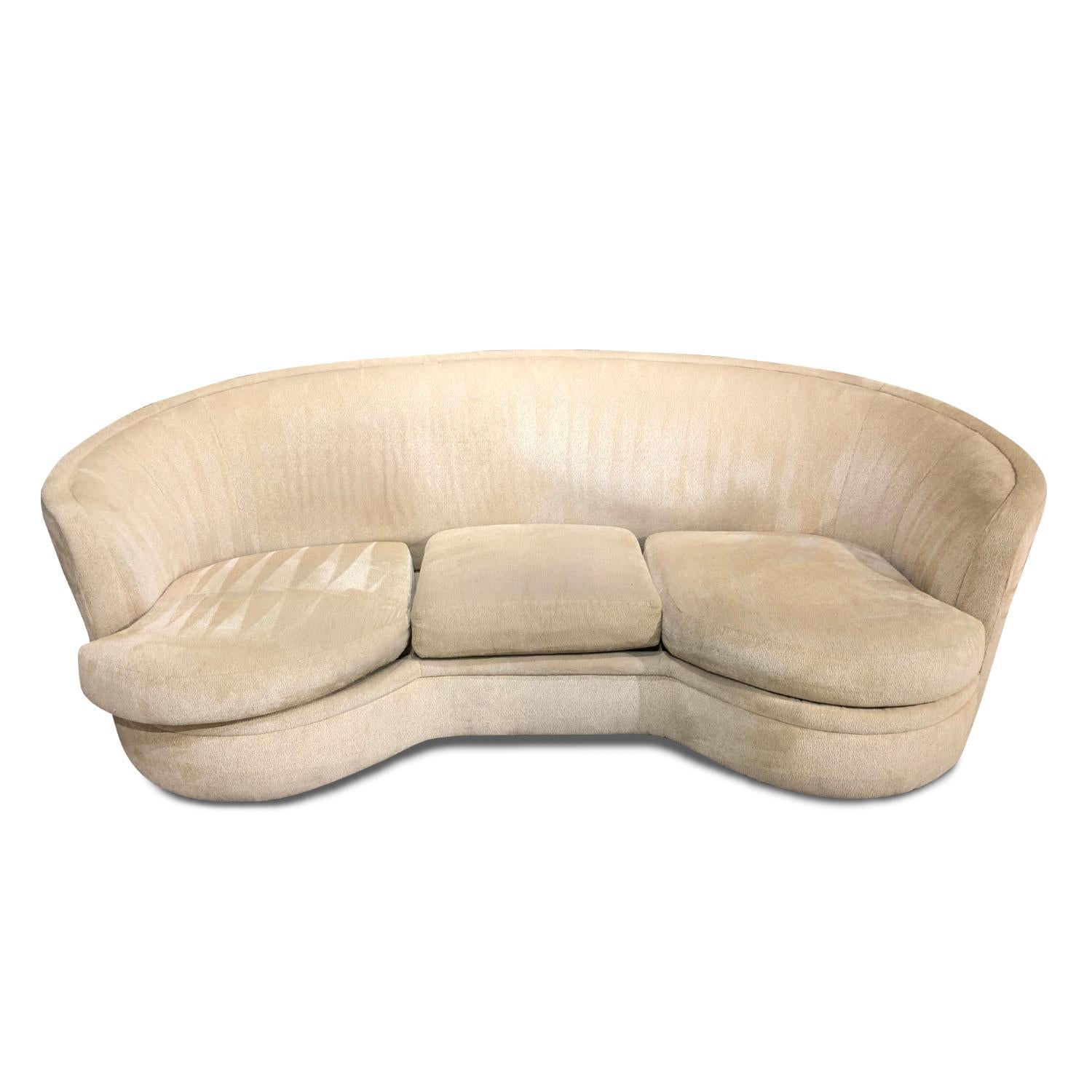 The crescent shaped, curved sofa was made famous by legendary designers. Kidney bean shaped couches have long been desired by Mid-Century Modern collectors, but this beauty traverses all styles. The sofa has been professionally steamed clean is