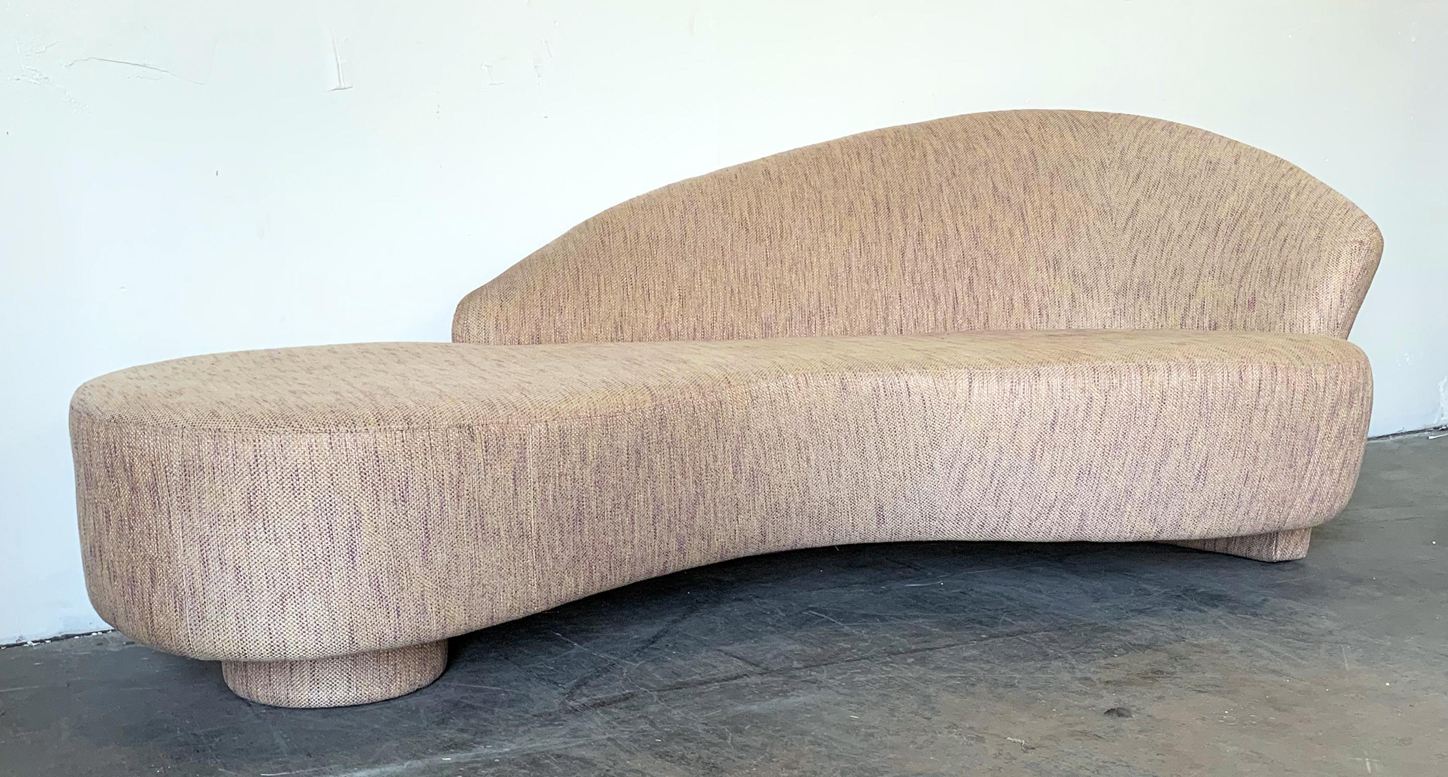 This sofa is absolutely stunning! It's a custom made Postmodern biomorphic / serpentine cloud sofa from the mid-1990s. The sofa features a single disc base with the back extending downward also as a leg.

This sofa is very reminiscent of Vladimir