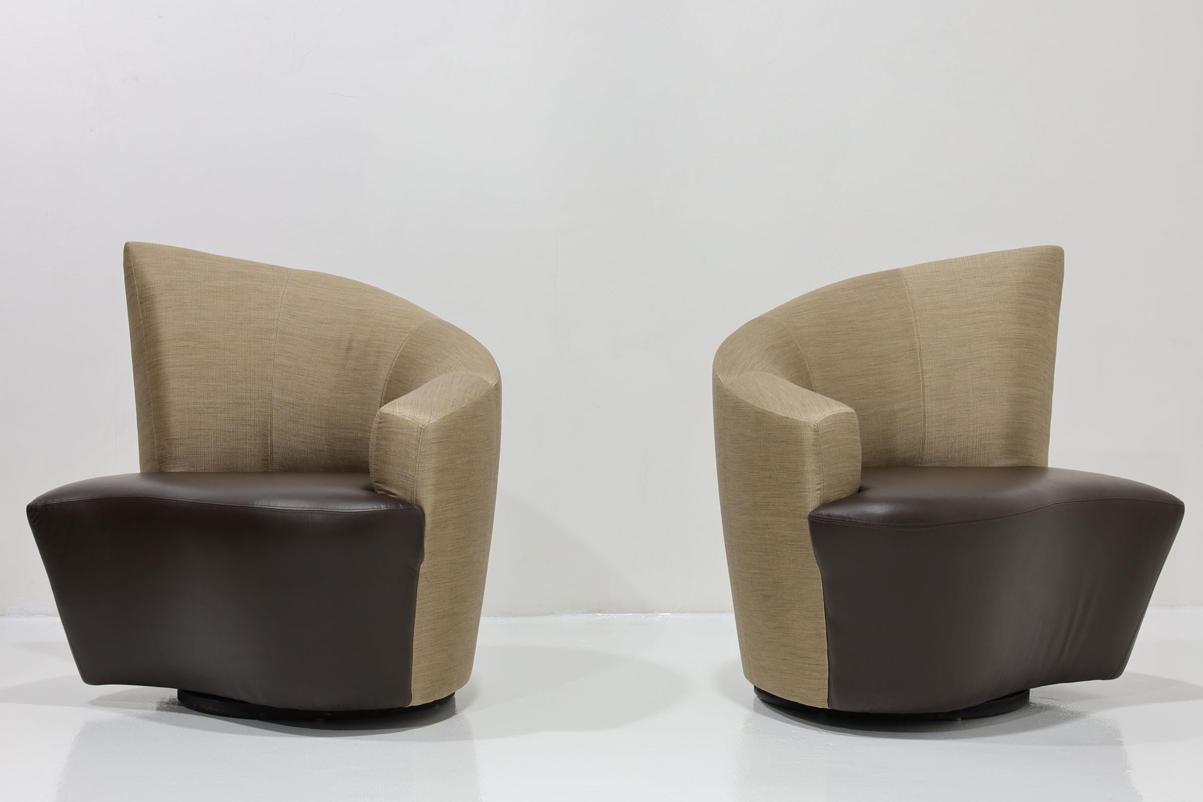 A Post Modern pair of Vladimir Kagan Bilbao swivel chairs upholstered in silk and leather circa 1990s. Enamored with Bilbao, Spain, the Bilbao chair is a manifestation of Vladimir Kagan's impressions from his time spent on holiday. He was especially
