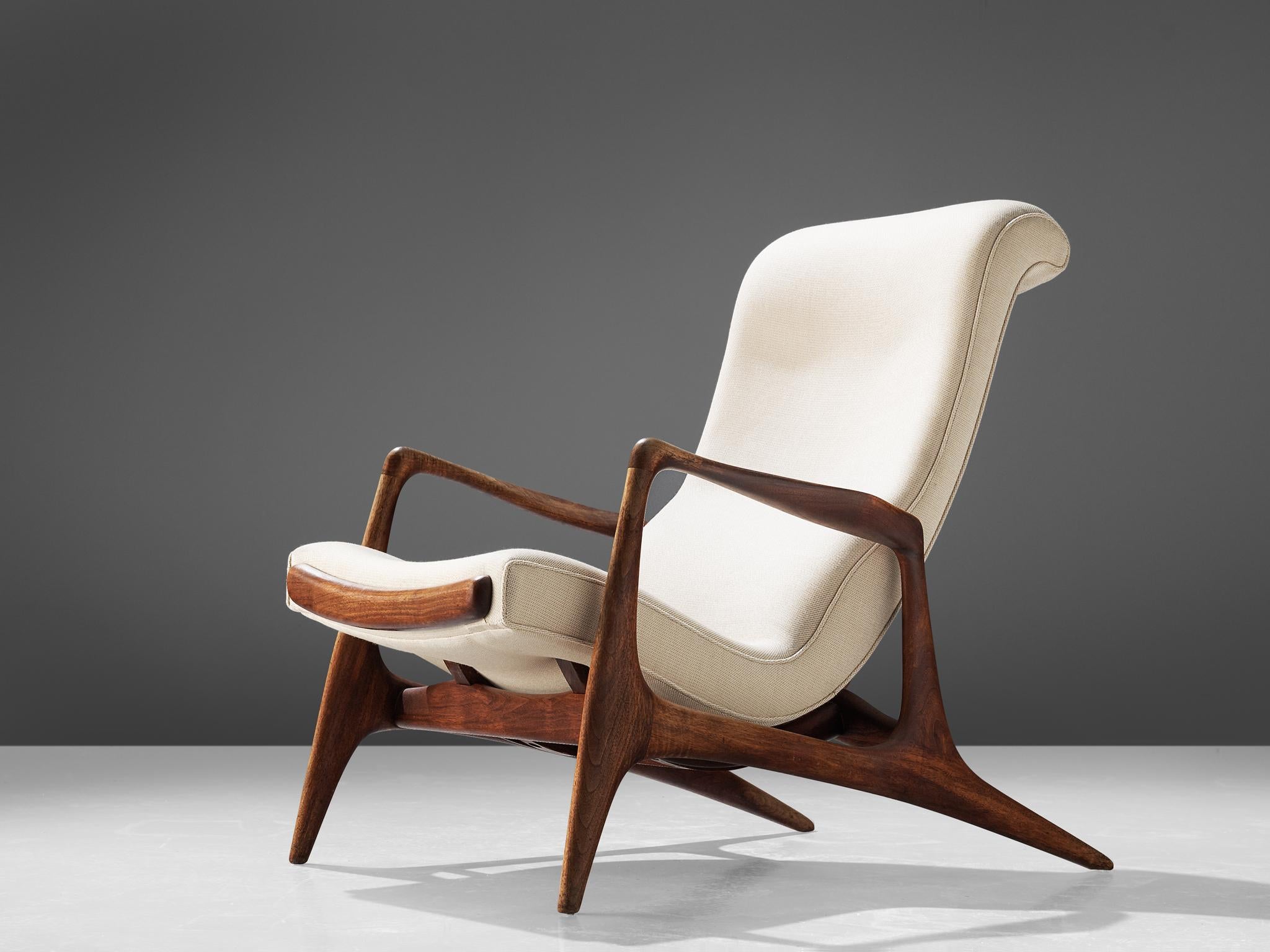 Vladimir Kagan for Dreyfuss, 'Contour' chair, teak and ivory fabric, United States, 1950s.

This lounge chair by Kagan is sculptural and delicate. The frame, executed in teak and carved and detailed in an exquisite manner. The back legs are long