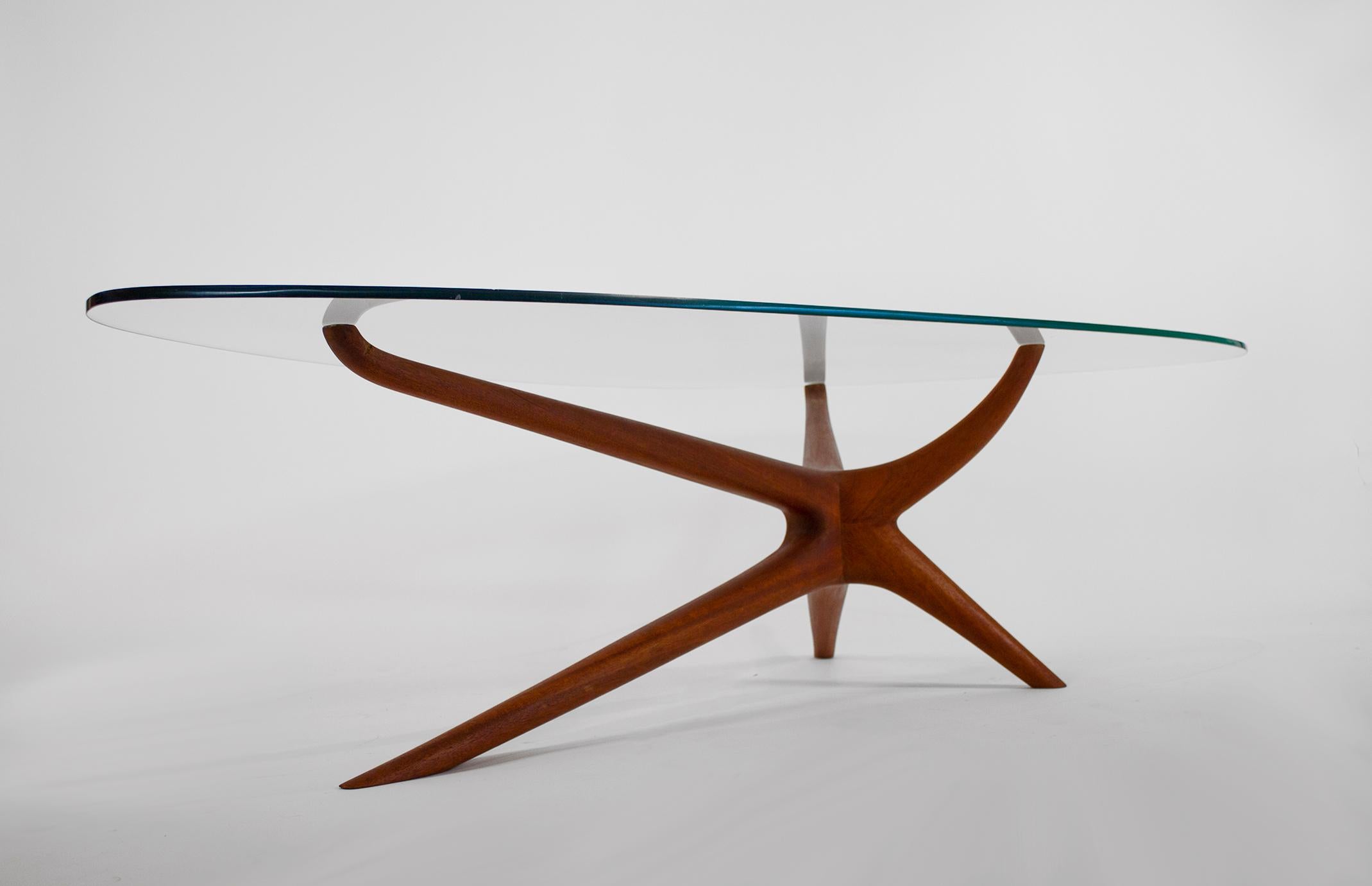 Tri-symmetric shaped coffee table, circa 1953. Solid mahogany with original glass top. In the manner of Vladimir Kagan with cleaner joinery.