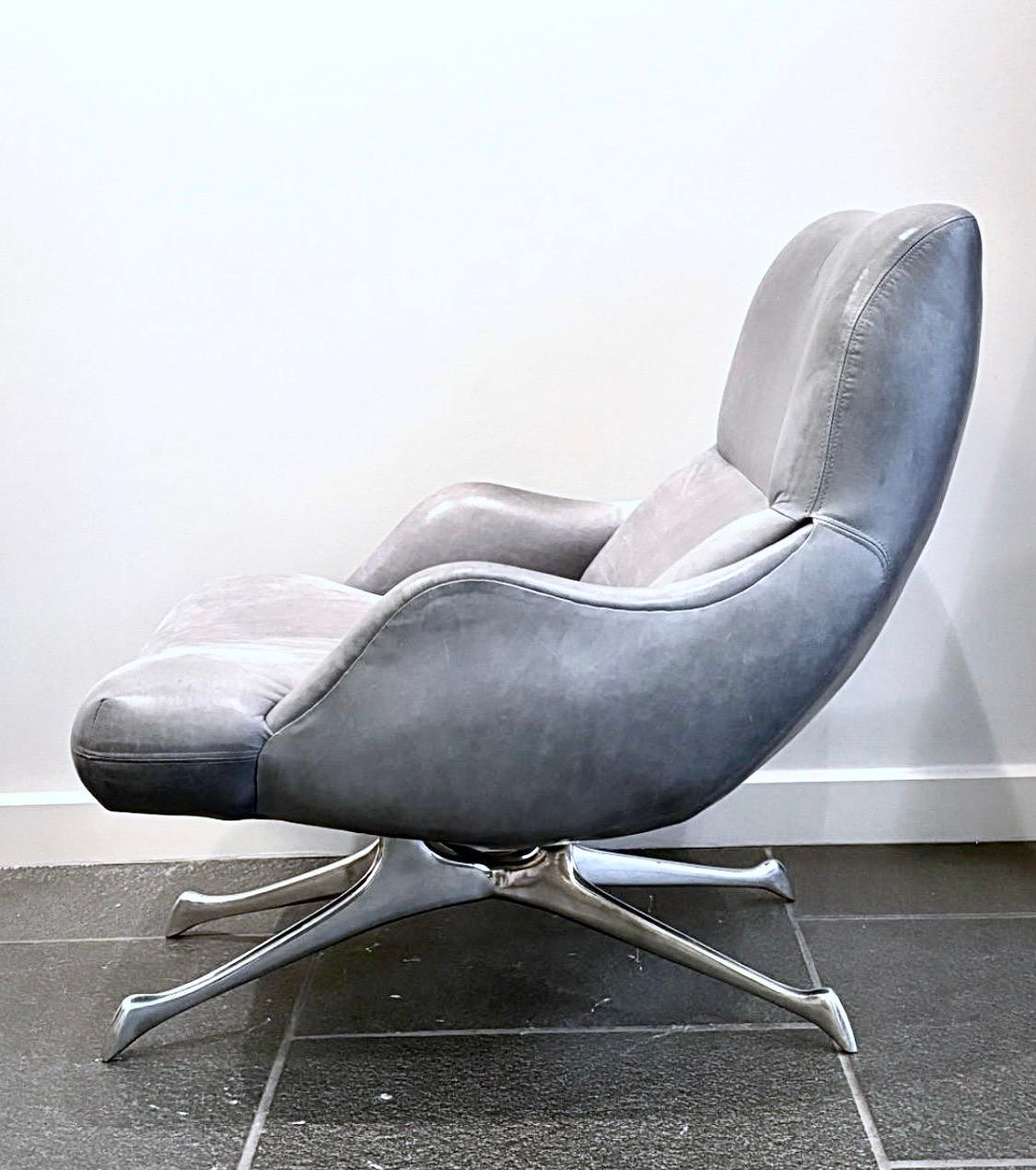 Vladimir Kagan VK Armchair, Made in Italy. Gray Blue leather. Polished aluminum base. Originally designed as the Contour Collection (Trisymmetric Chaise Longue and Armchair Lounge) in the late 1950’s as a metal version of his tri-symmetric wood