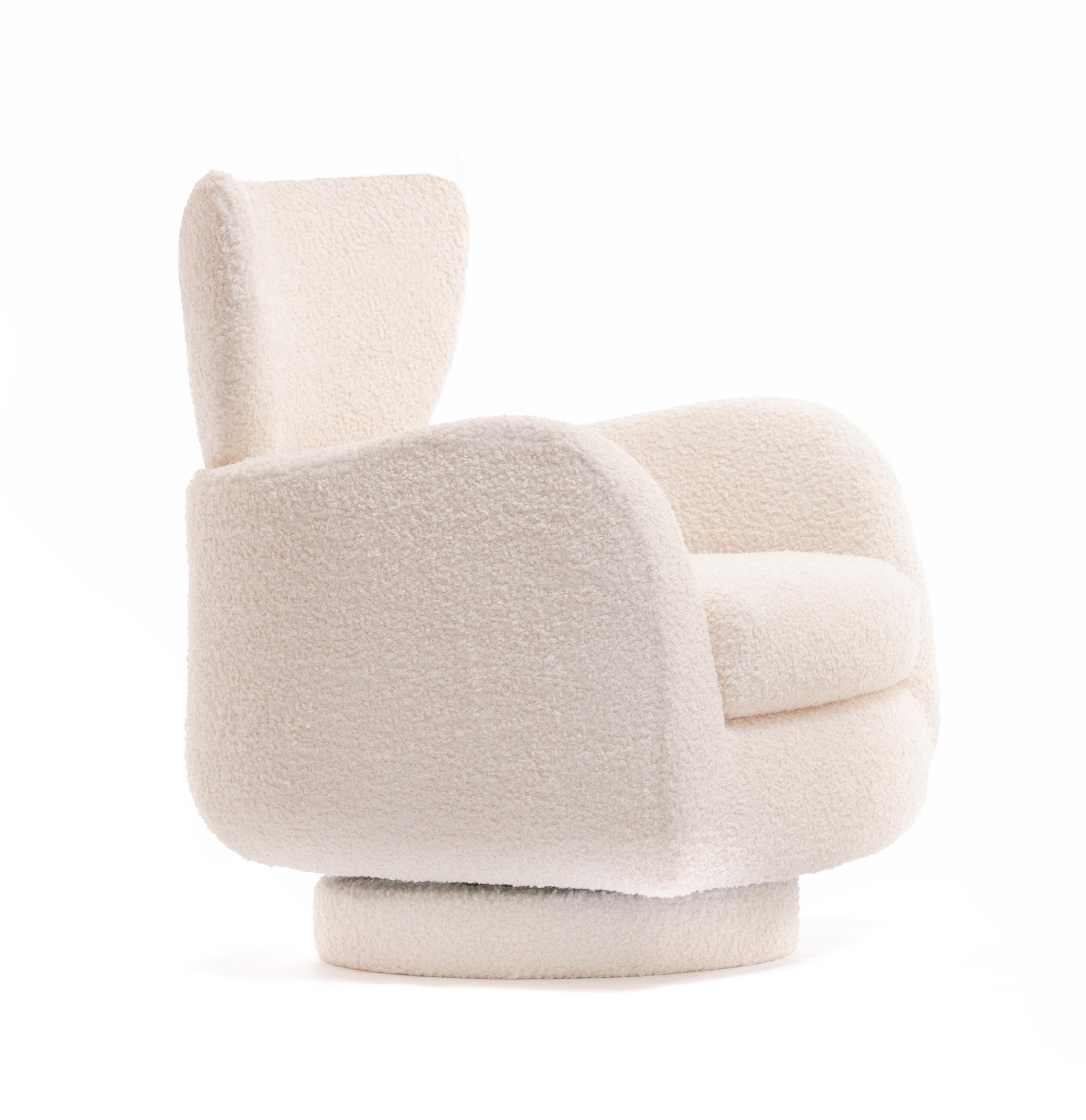Vintage Vladimir Kagan wingback tilt and swivel lounge chair - newly and freshly reupholstered in ivory bouclé fabric - for Directional. Sculptural and Classic Kagan design, this chair is surprisingly comfortable. The seat back wraps around your