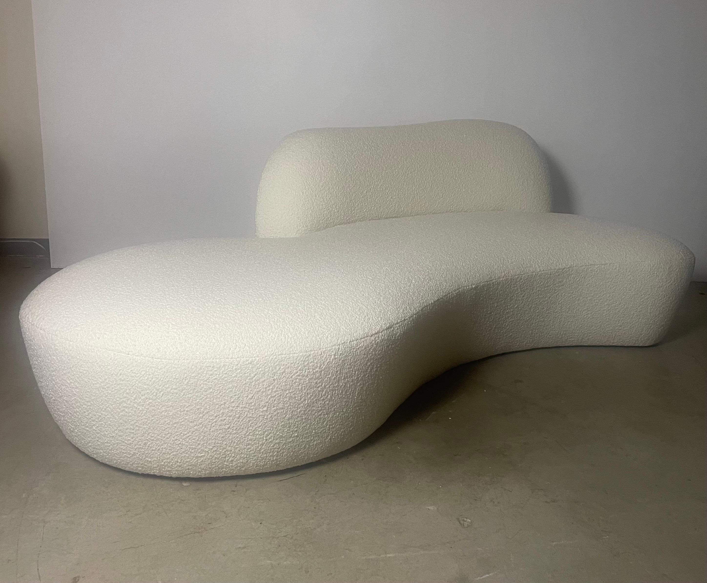 This is an authentic Vladimir Kagan Zoe sofa, one of his most iconic designs. The sofa features a curved shape that is both elegant and comfortable, with deep seats and plush cushions. It is upholstered in a new cream boucle fabric. 