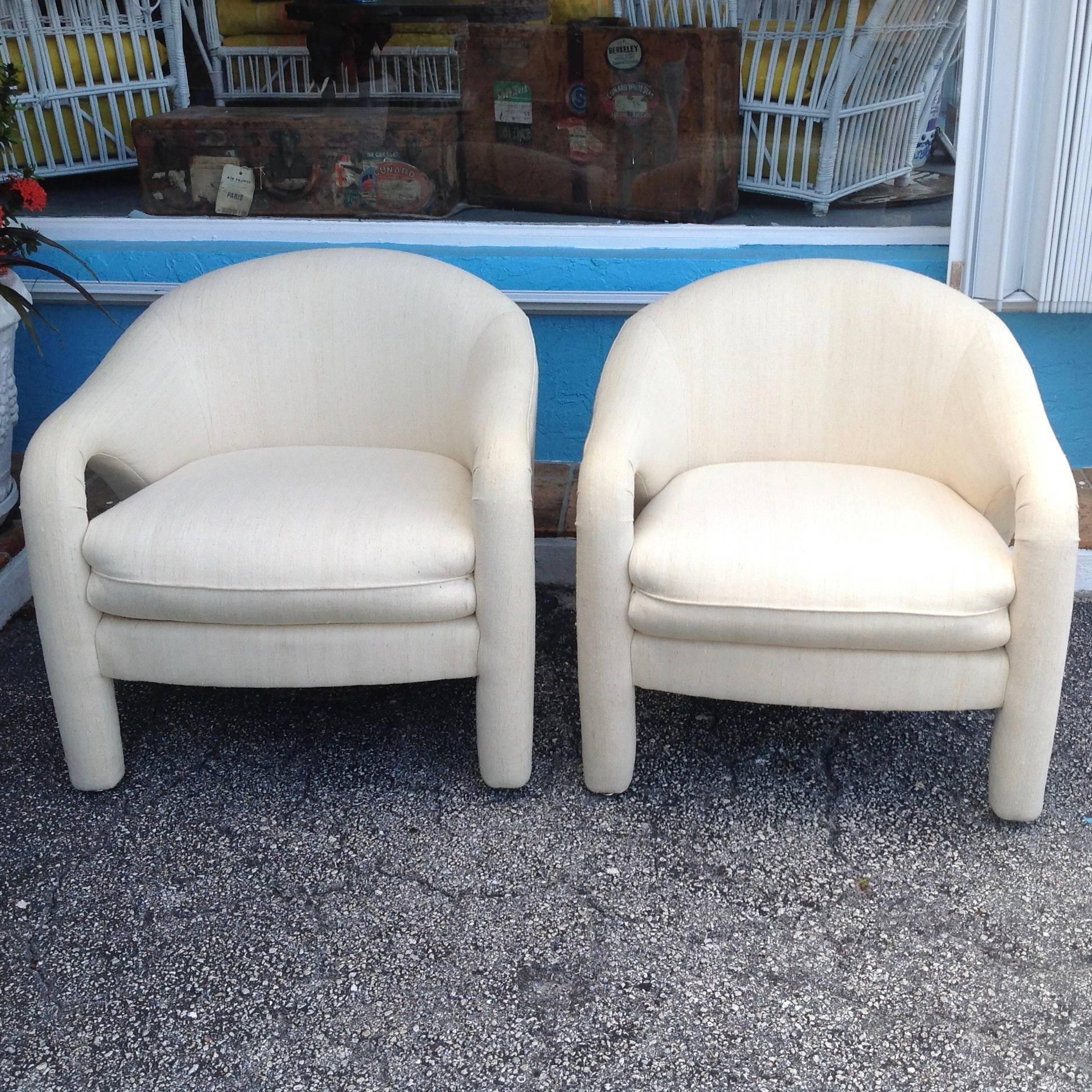 A superb pair of lounge chairs inspired by the iconic designer. 
Generously scaled with swooping lines and covered in lovely ivory linen.
Bearing the Weiman labels.