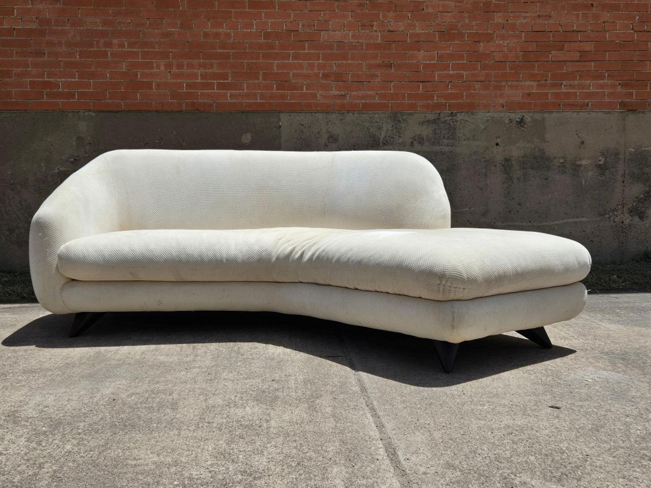 A rare find, the Tangent sofa with an open chaise feature by Vladimir Kagan Angle Tangent Sofa for Preview is an exquisite addition to any mid-century modern collection. This sofa boasts large, bulbous wood legs that offer both durability and