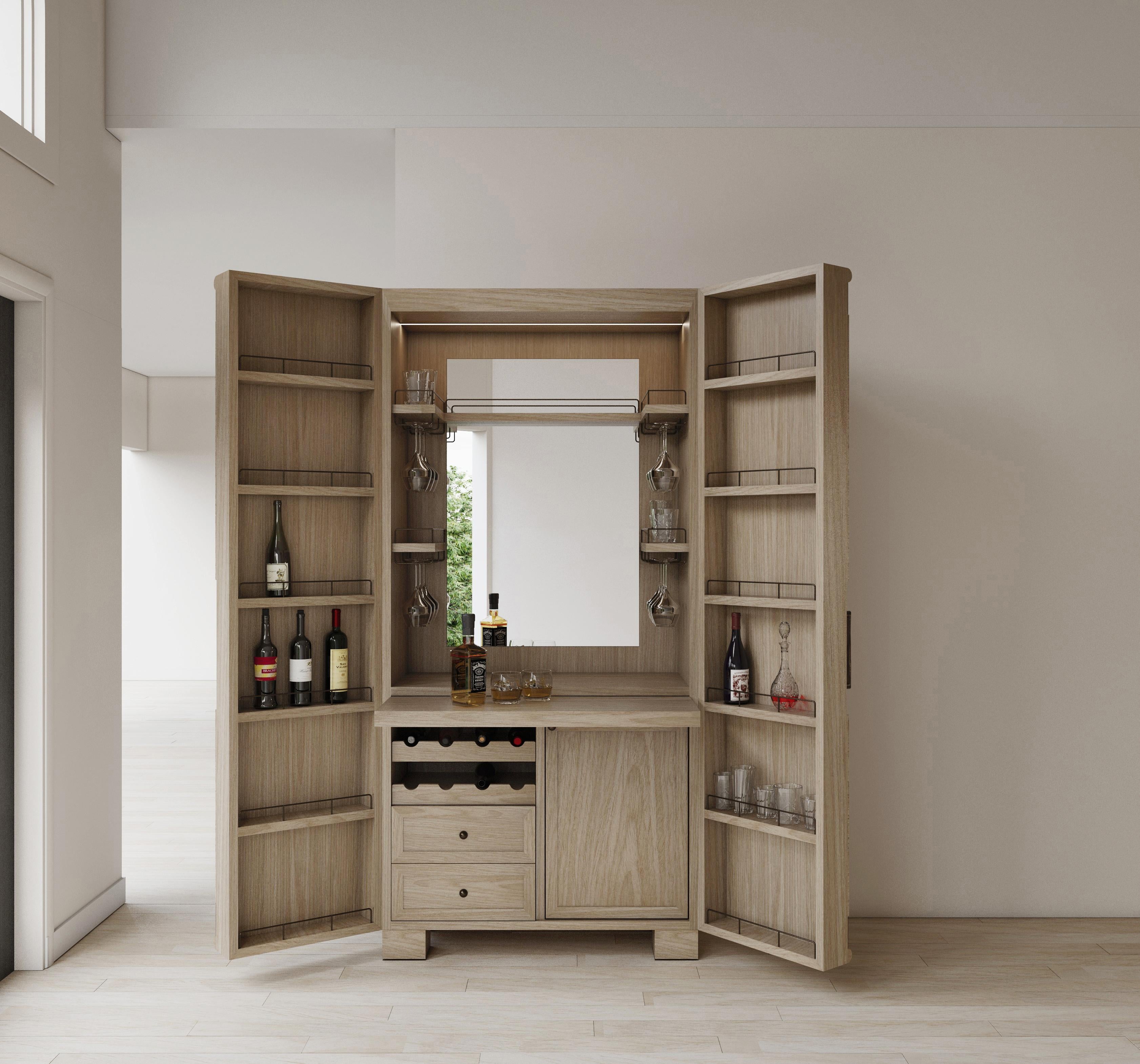 Elegant Dry bar with oak wood structure finish in smooth polyurethane. Doors framed in antique brushed bronze, bronze hammered  handles,  Inside includes  mirror with drawers, bottle space and pull out tray. 43.30