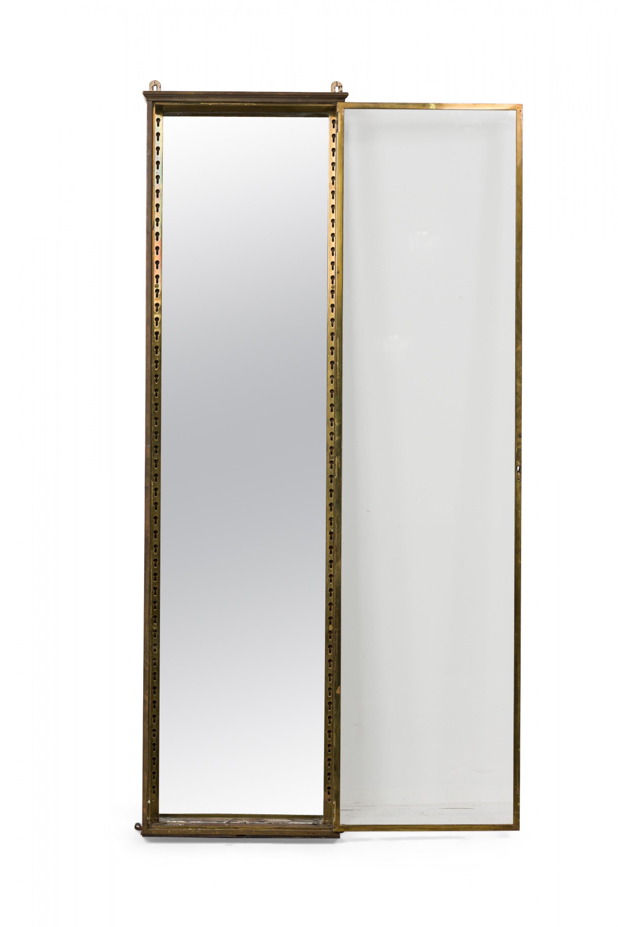 French Victorian bronze and glass wall mount rectangular single column vitrine with a patinated bronze frame and hinged glass door with interior fittings for adjustable shelves, opens with a glass door. (Embedded metal plate reads 