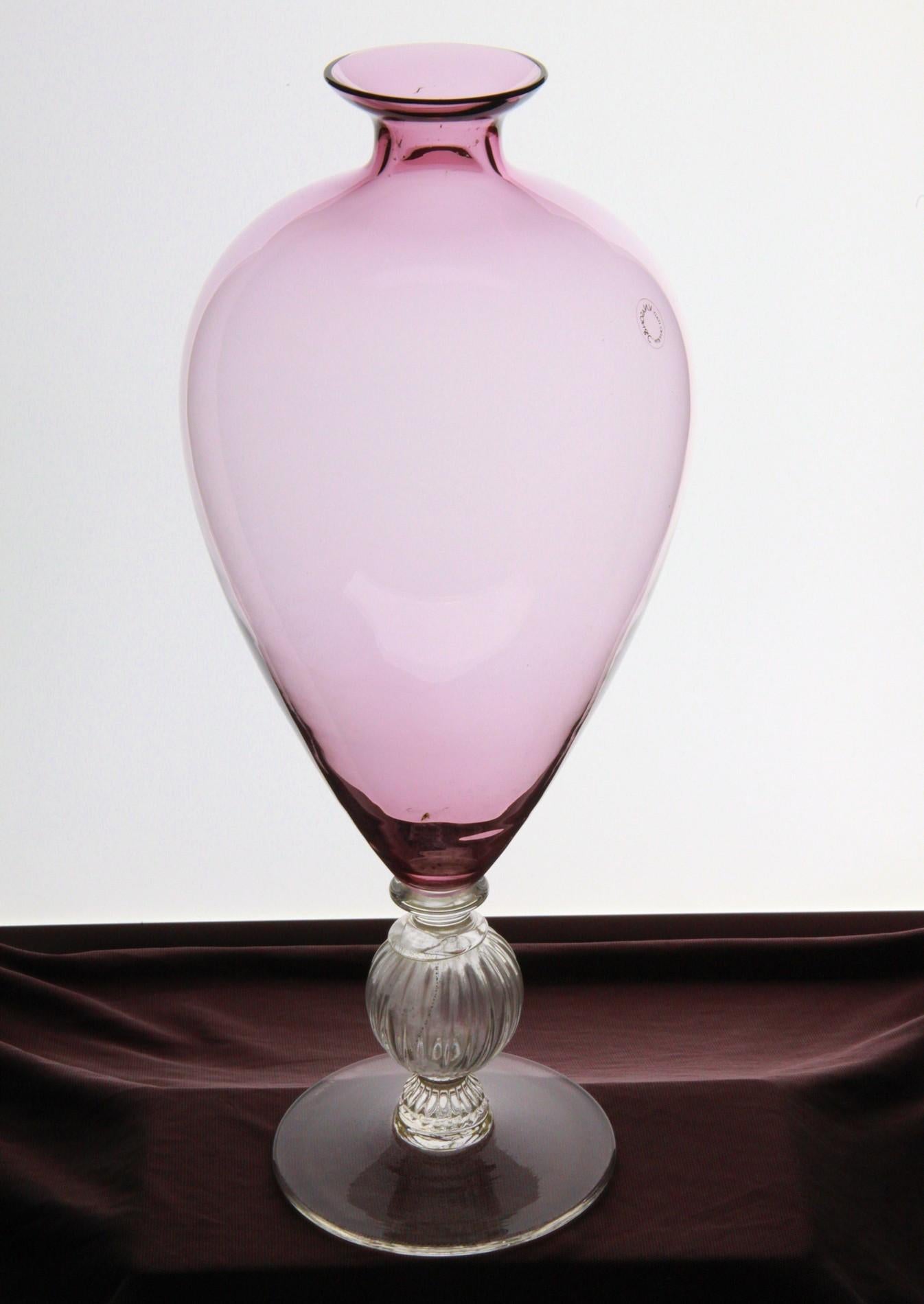 Enchanting vase made by one of the top manufacturers in Murano, Venice. Shows a perfect blown body in Amethyst with applied a foot handmade with a rigadin body with gold leaf applied.

During the 20s and 30s there was a re-discover of the