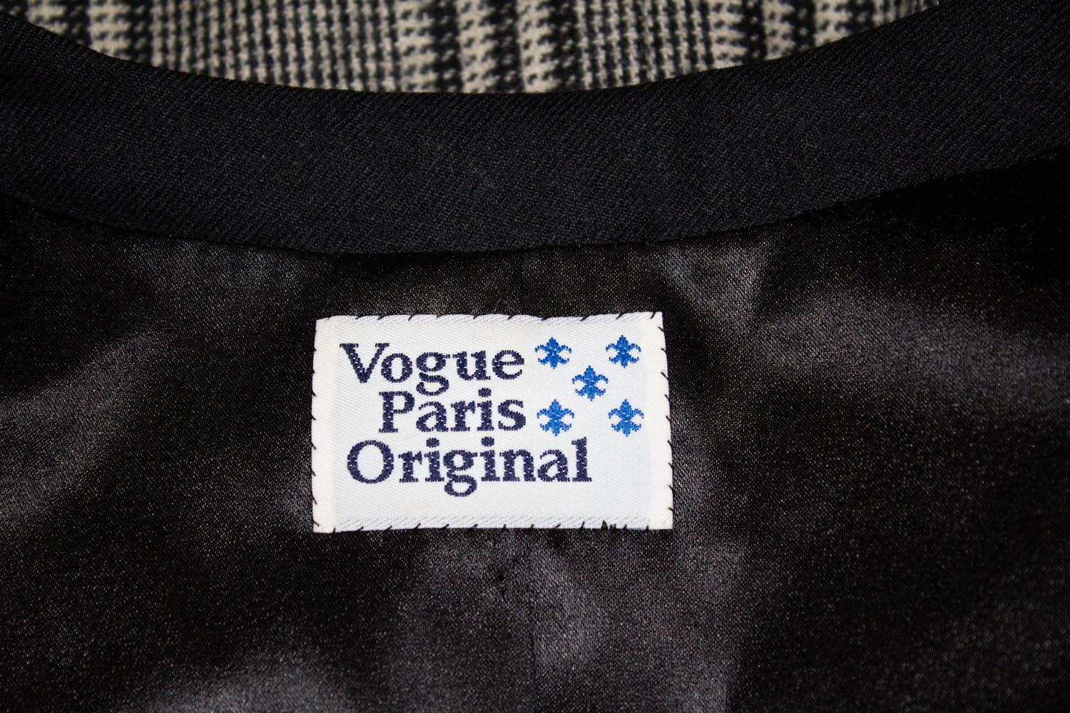 A wonderful and chic vintage jacket by Vogue Paris. The jacket is in a black and white wool check, and has a one button fastening with two pockets on either side., and a v neckline.
It is fully lined. 
Measurements: Bust up to 38'', length 21''