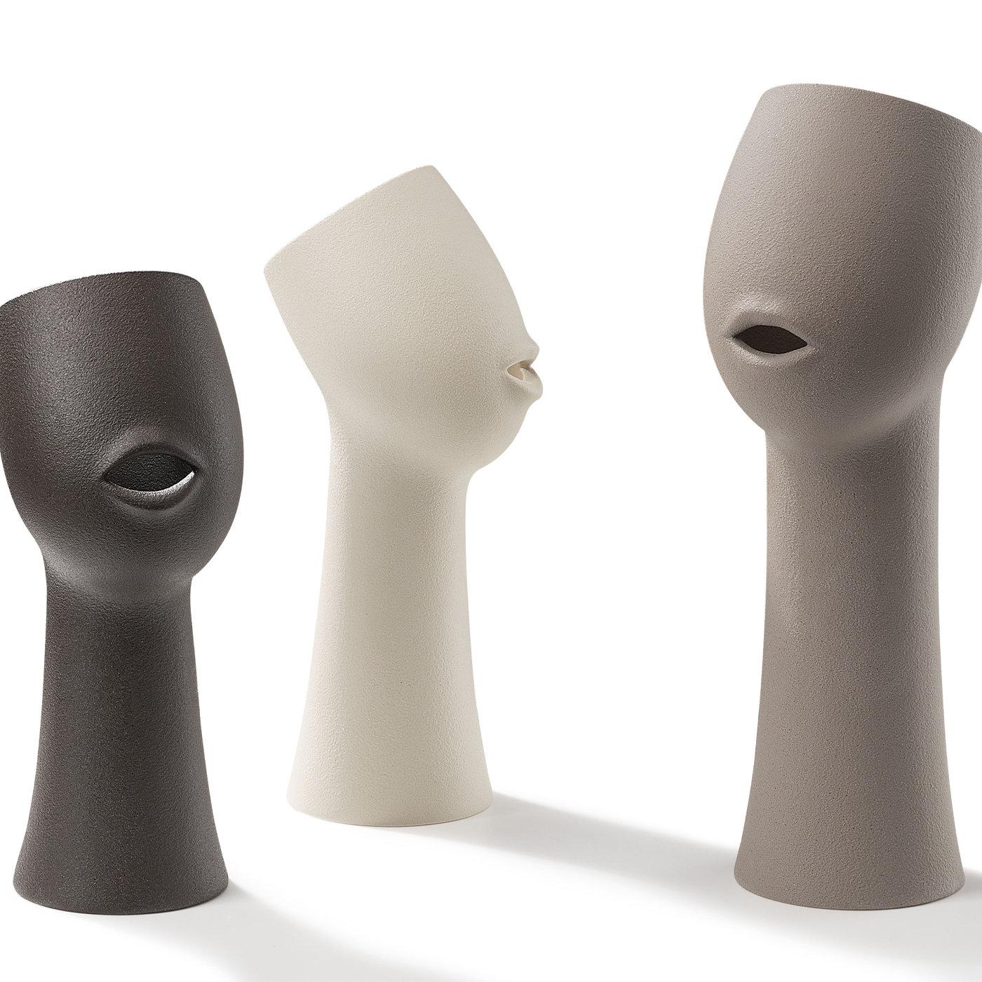 Characterized by the form of a neck and face and featuring a small opening in the shape of a mouth, this fascinating Voice Vase is 43 cm tall and crafted in gray ceramic. Delightfully unique, it will compliment any contemporary setting.