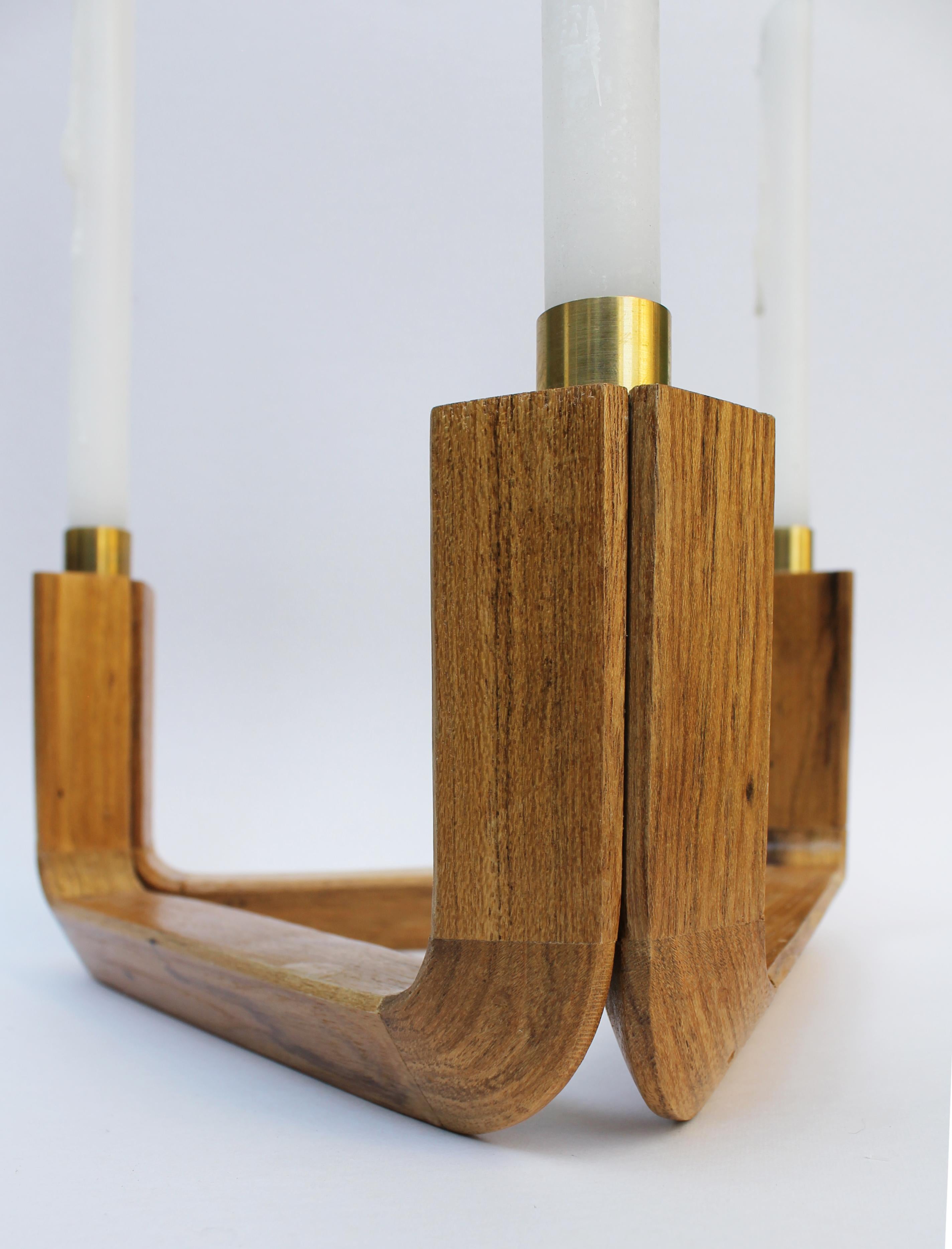 Void candelabra - 3 candles

   Despite being material, the collection name contains the immateriality that defines it - vøid. 
   The concept is to represent the empty space that is within the limits established by materiality, as the wooden parts