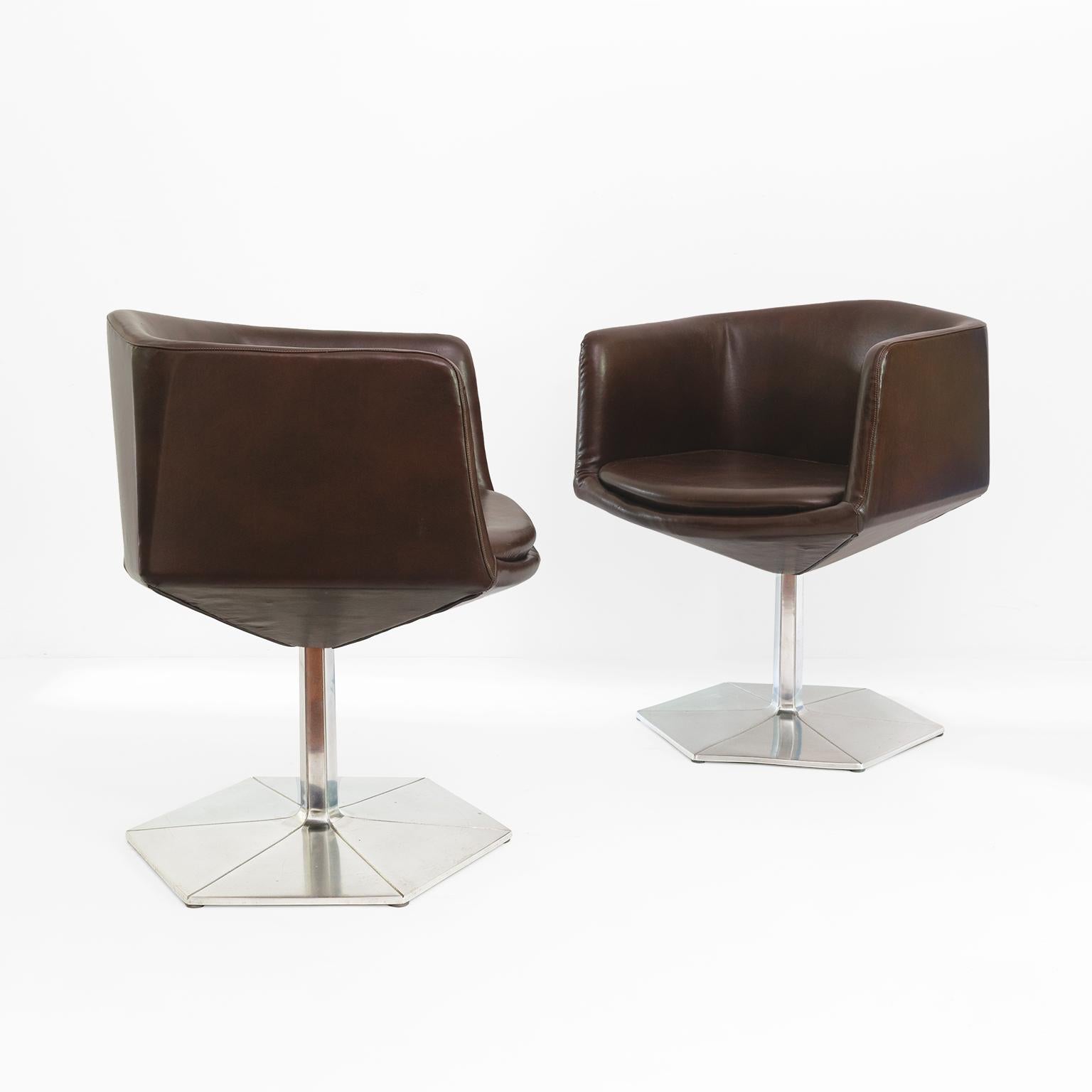 Voitto Haapalainen pair of “Prisma” chairs with faceted bodies which swivel on polished cast aluminum hexagonal bases. Chairs are newly upholstered with a brown faux leather. Made by Martela OY, Helsinki. Finland, 1970’s, signed on bottom of base.