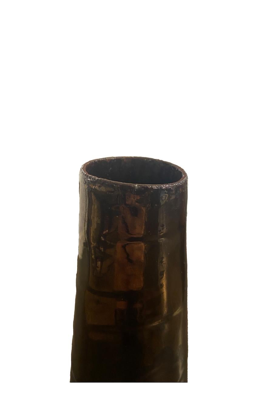 High stoneware vase, covered with dark grey and gold glazes. The piece is handbuilt rather than thrown and the bisque was sanded before firing.

About the designer

After studying fine arts in his native city of Le Havre in Normandy, he explored oil