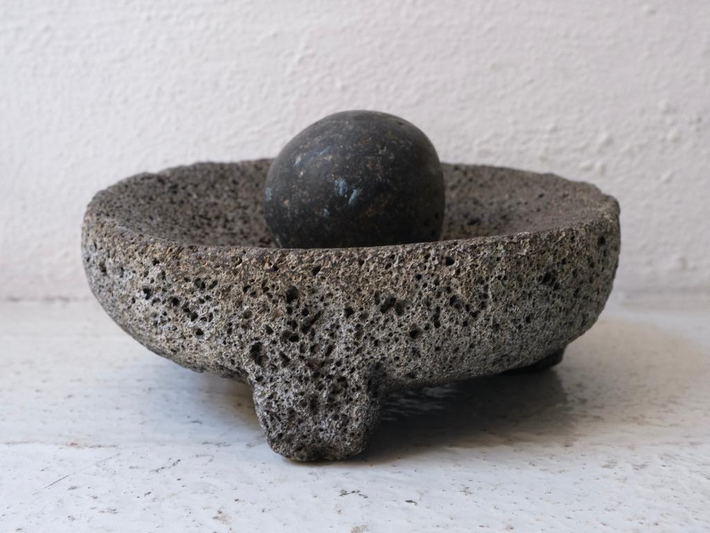 Volcanic mortar with pestle from Guanajuato, Mexico. Tripod base. Showing considerable wear.