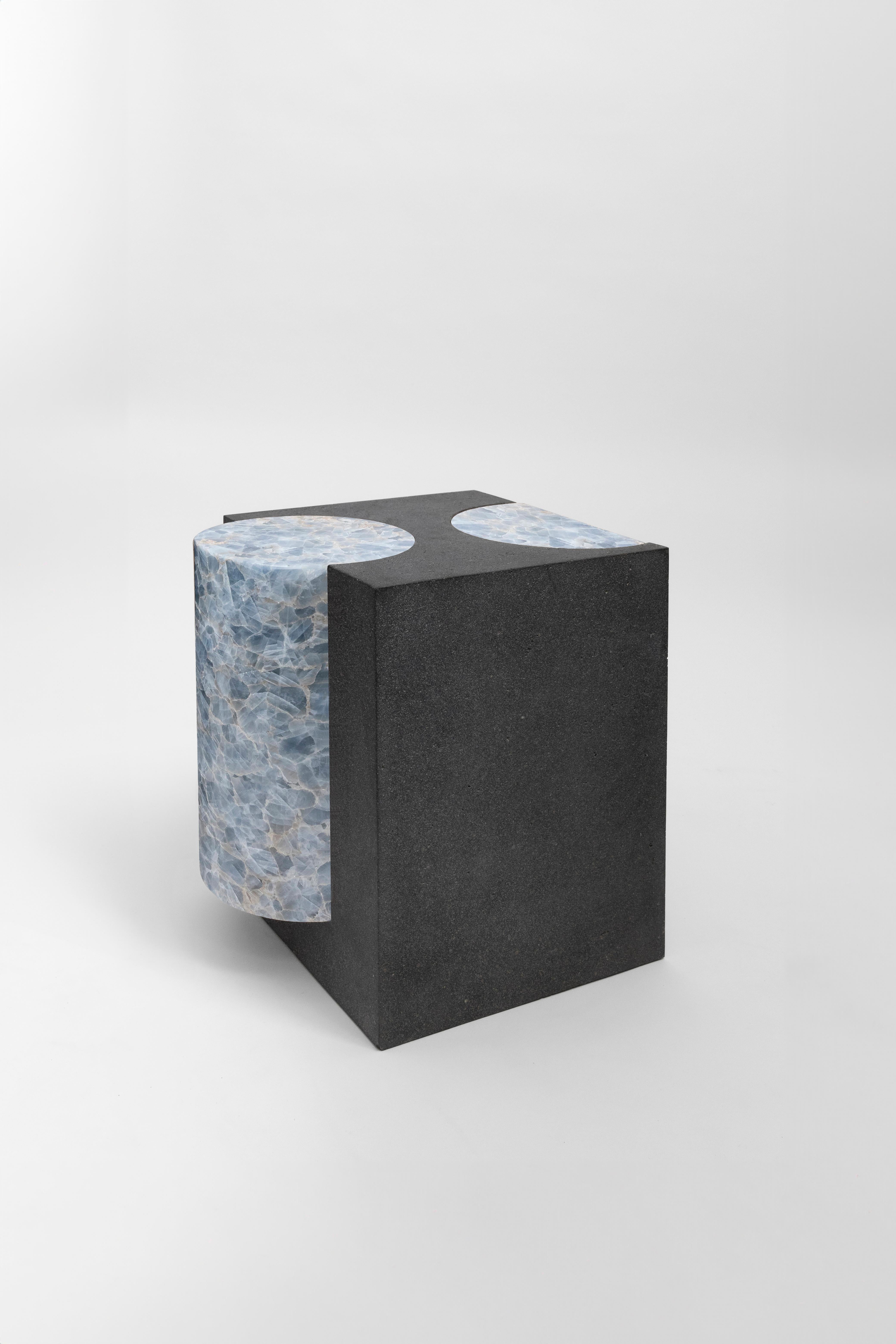 Materials: Lava stone and blue calcite
Indoors and outdoors
Side table / Stool

**As this work is made of natural stone, color and veins may vary from the photo**

Through an abstract geometric language where cubes and cylinders playfully alternate,