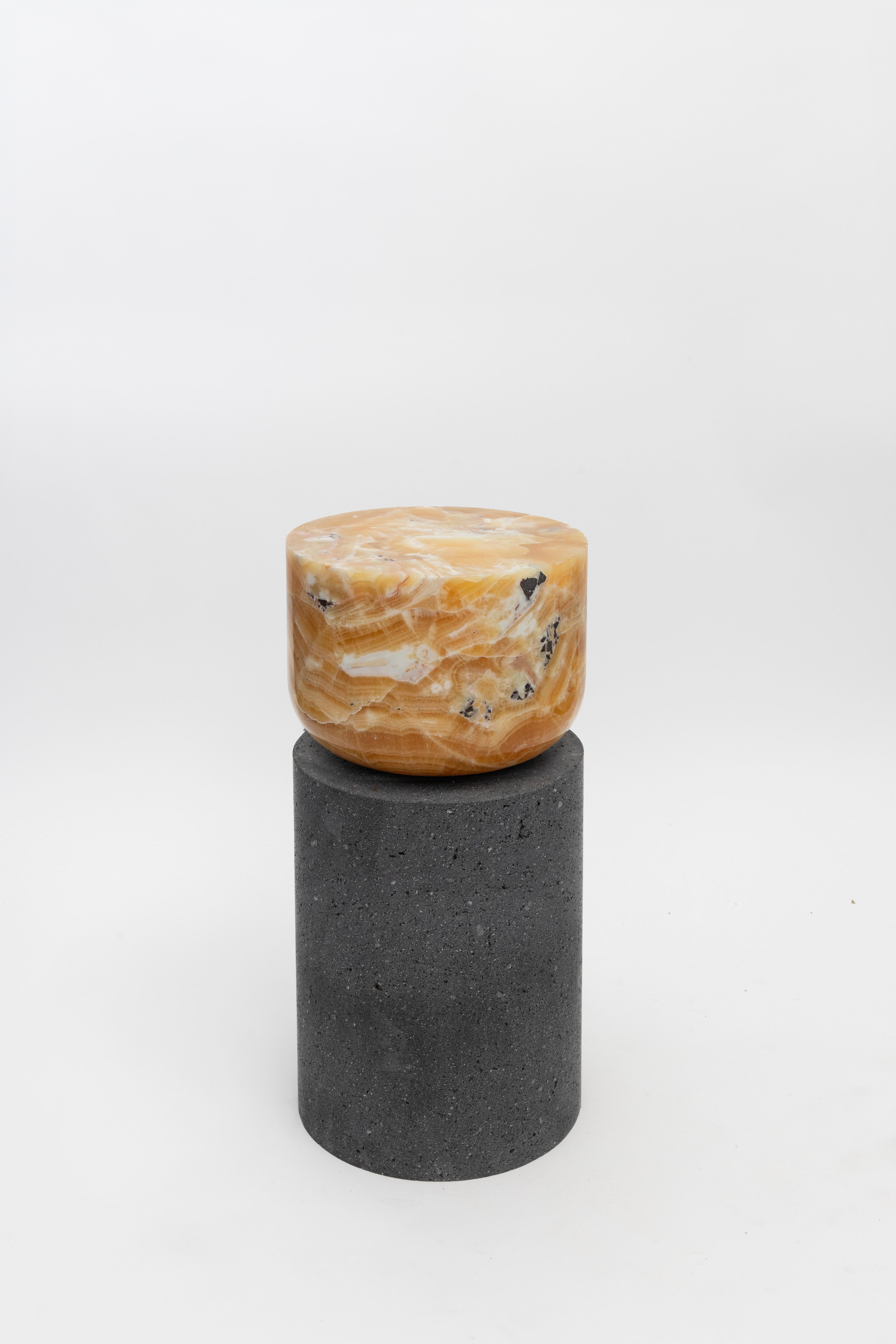 Materials: Lava stone and pineapple onyx
Indoors and outdoors
Side table / Stool

Through an abstract geometric language where cubes and cylinders playfully alternate, these stools represent the millenary connections existing inside the Earth; they