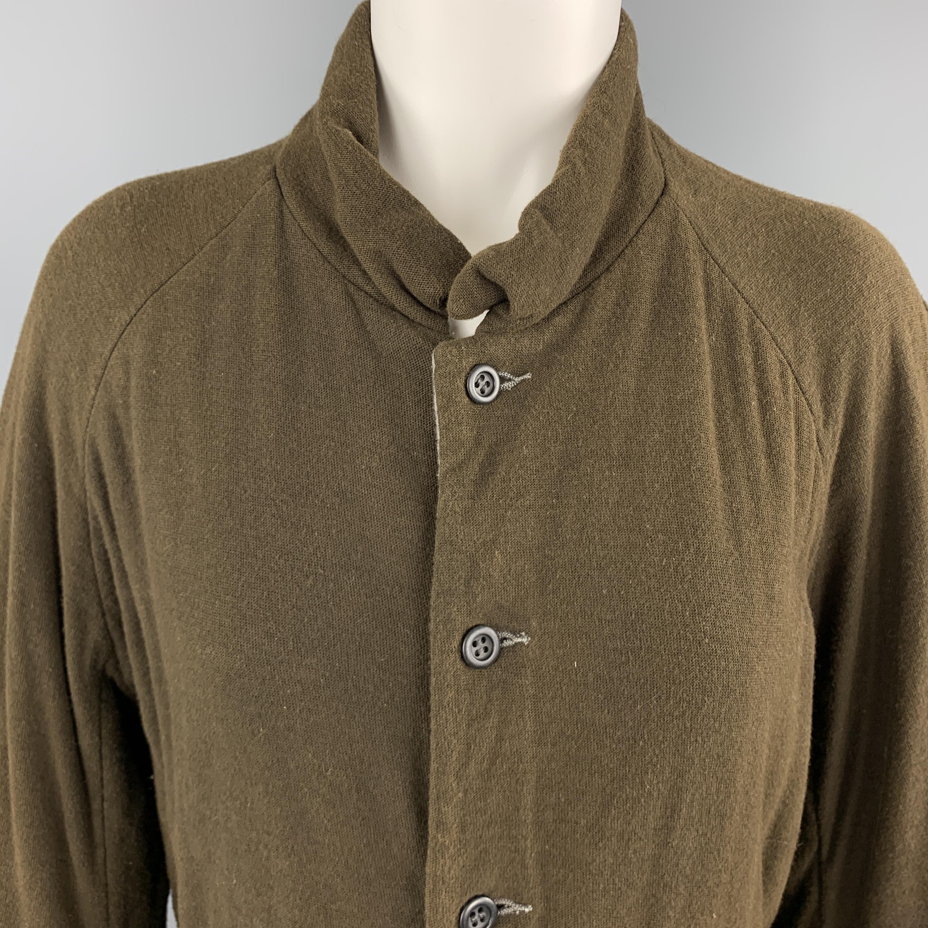 VOLGA VOLGA jacket comes in textured olive jersey with a band collar, button up front, slit pockets, and gray reverse side. Made in Tokyo.

Excellent Pre-Owned Condition.
Marked: S

Measurements:

Shoulder: 18 in.
Bust: 40 in.
Sleeve: 25 in.
Length: