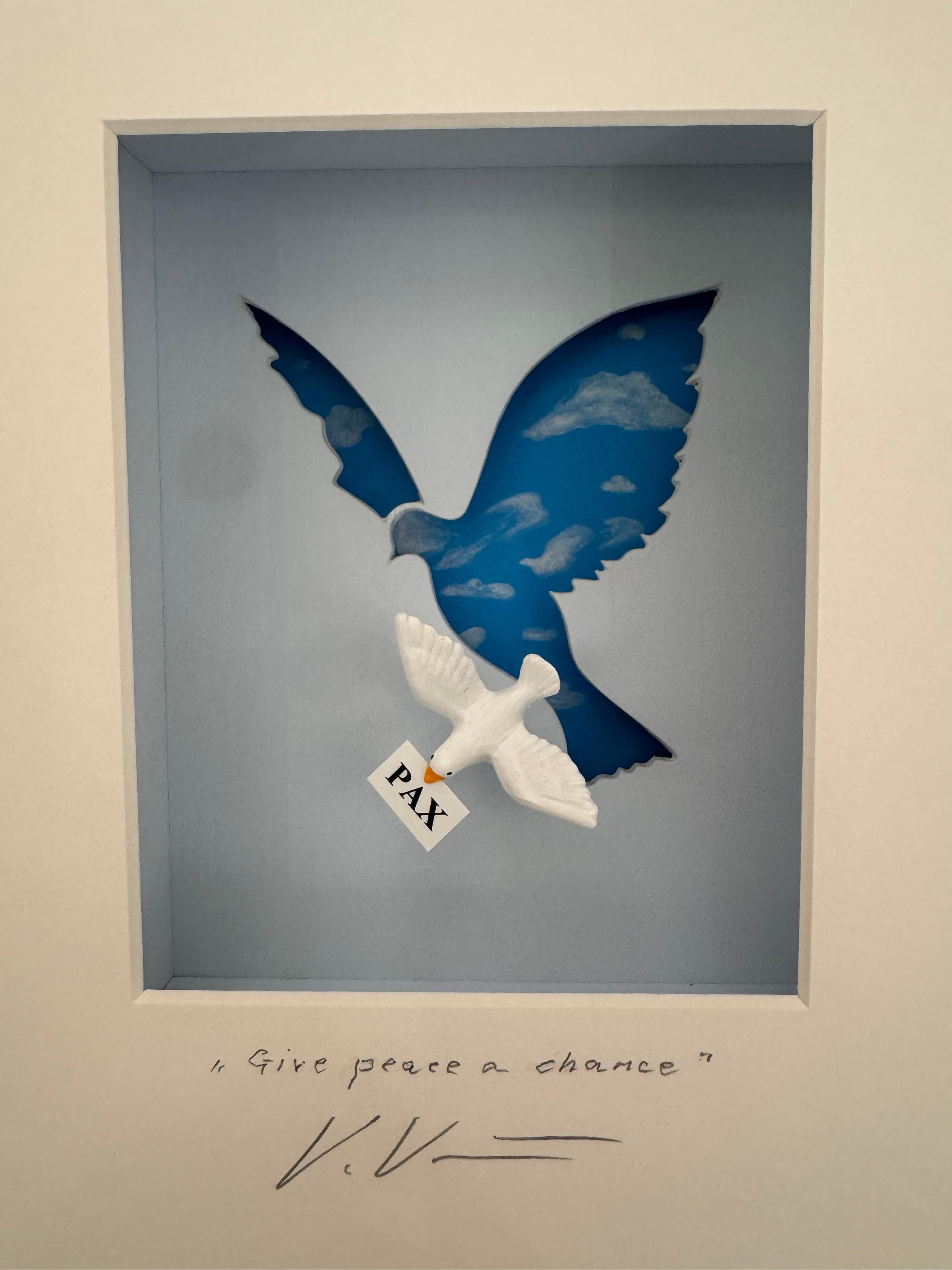 "Give Peace a Chance" is an original mixed media artwork by Volker Kuhn. The work is hand-signed by the artist below the artwork on the mat. 28 x 25 cm framed in a silver-gold wood-framing with simple hanging mechanism on back.  Stamp certified on