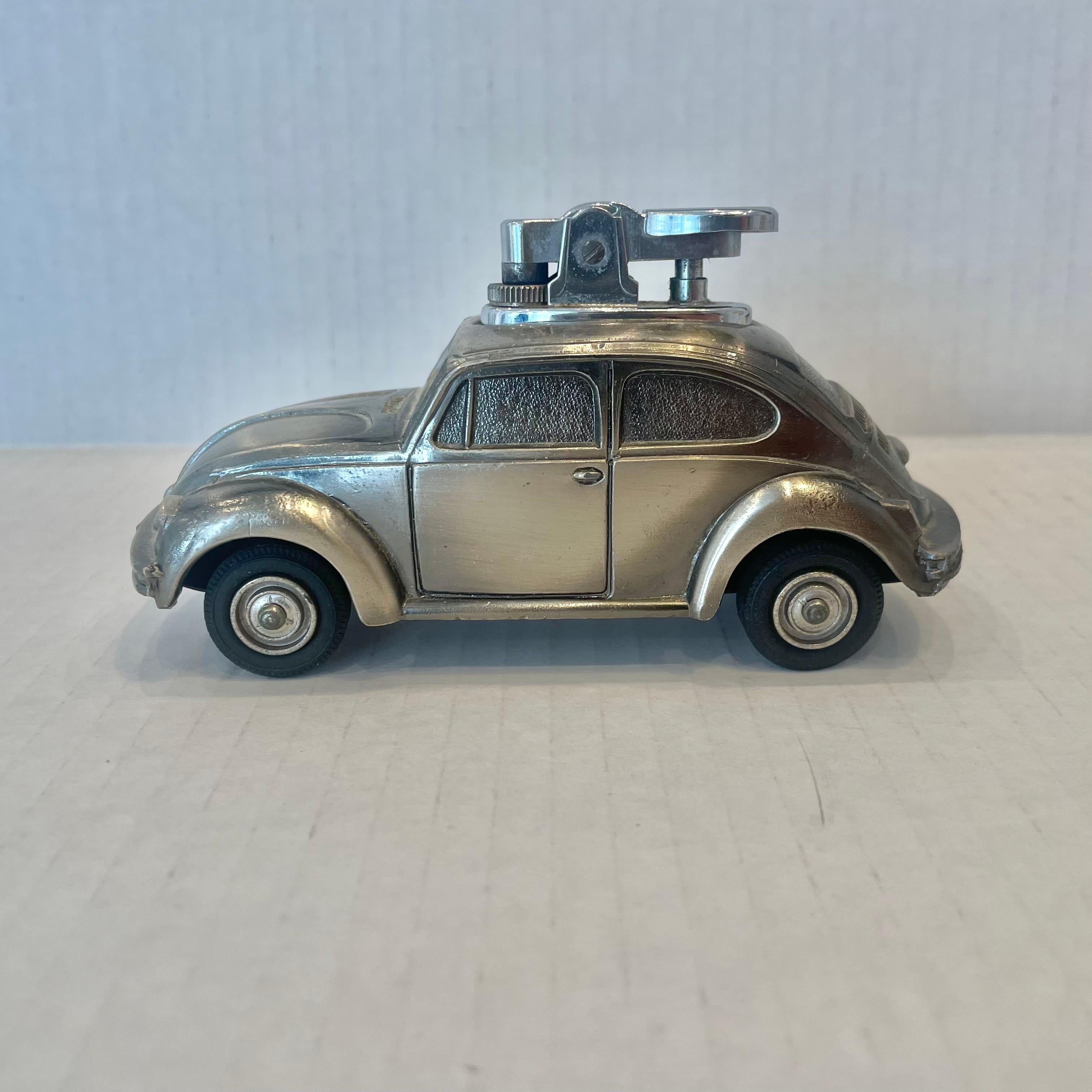 Fun, vintage table lighter in the shape of a Volkswagen Beetle. Made completely of metal with a hollow body. Great silver color with nice details throughout and finished off with thin rubber tires. Cool tobacco accessory and conversation piece.