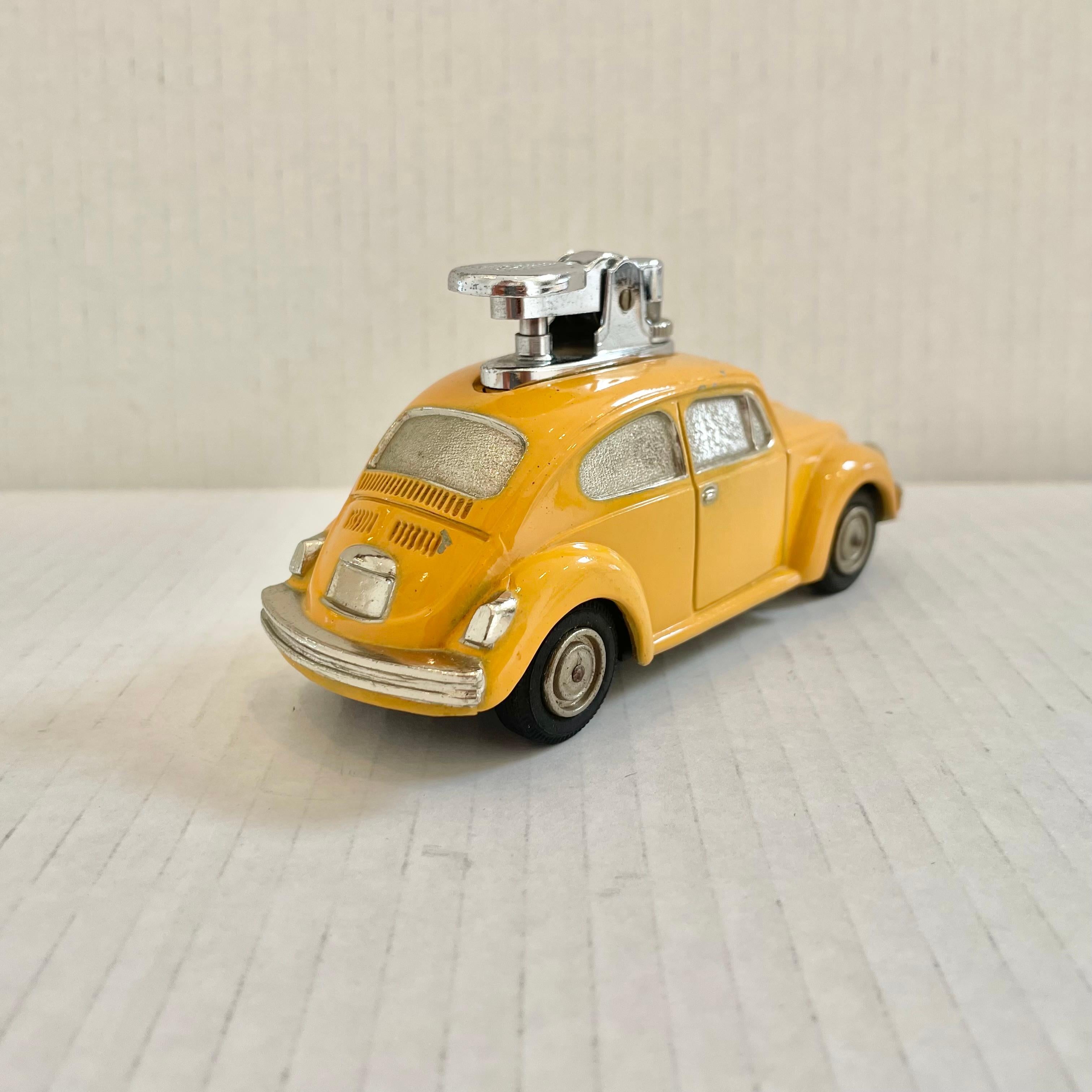 Fun vintage table lighter in the shape of a Volkswagen Beetle. Made completely of metal with a hollow body and painted in a classic taxi cab yellow. Great details throughout and finished off with thin rubber tires. Cool tobacco accessory and