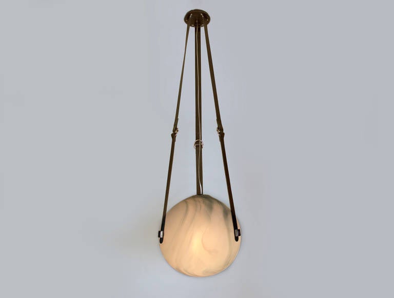 Large handblown glass ball, sandblasted to have an alabaster appearance. The fixture hangs from three black leather straps with polished steel accents. The light comes from one standard based bulb with hangs from the leather canopy. (Max wattage 100