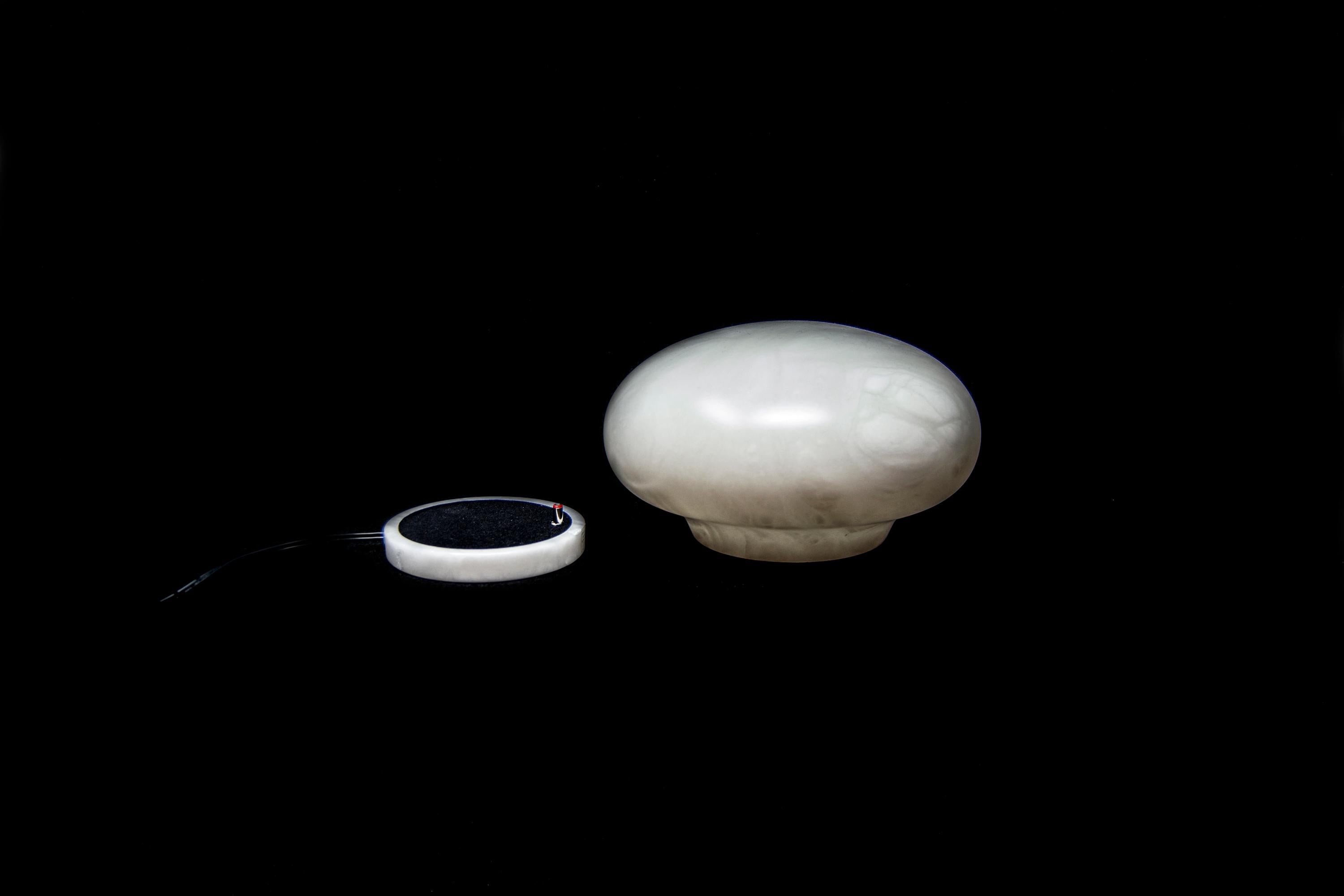 The lamp emerges in space lightly, as if it was a cloud. Turned on, with the spilling of light between the strips of the alabaster, seems to be made of paper, deceiving the observer. Designed by Setsu&Shinobu Ito is manufactured in Italy by
