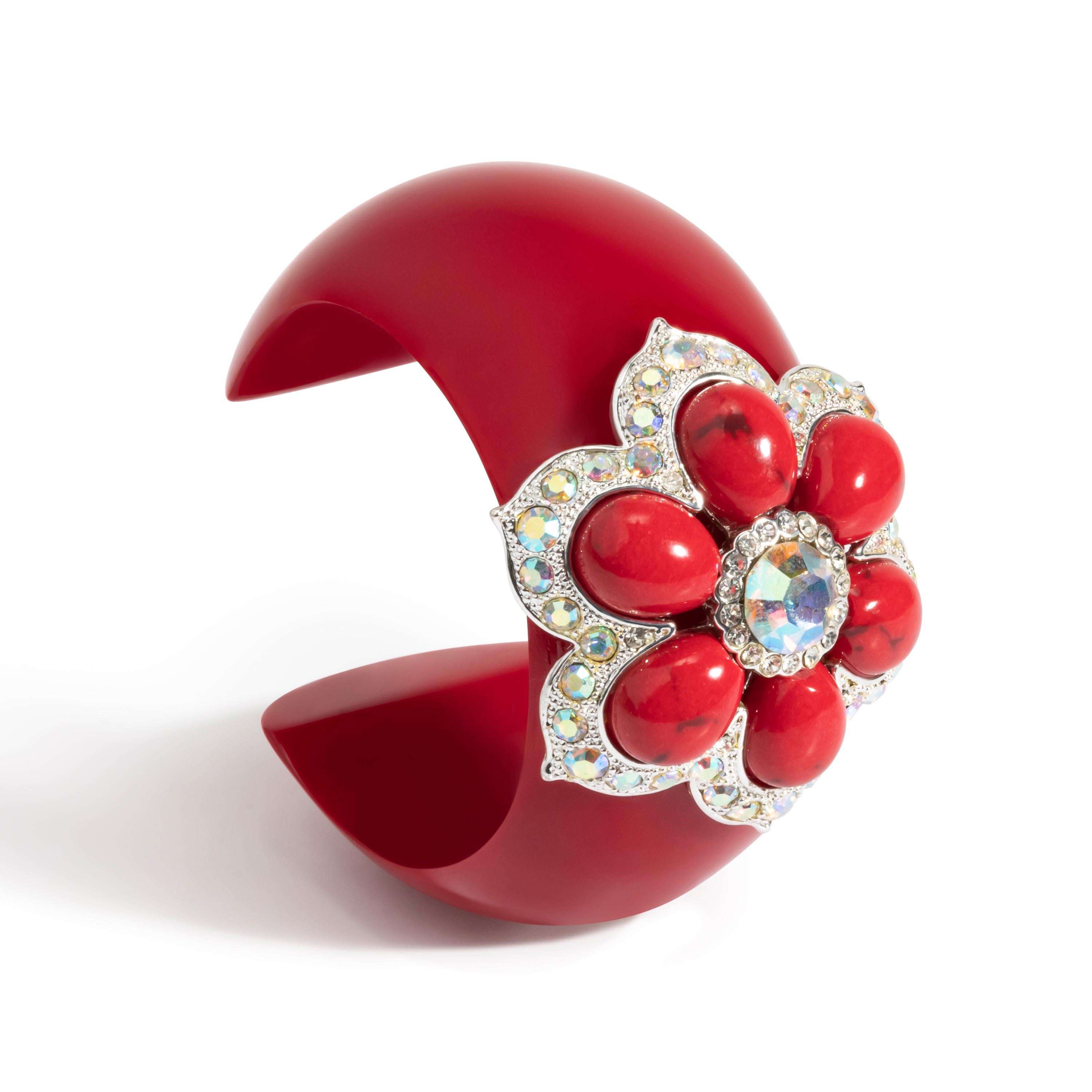 “Volver”Bochic red carpet bijoux jewlery, from the “IKON” private collection.  
A homage to Pedro Almadovar color motifs. The cuff features a parker rose.
The dangers red Rasin cuff is set with SWAROVSKI crystals, white plated with an incredible