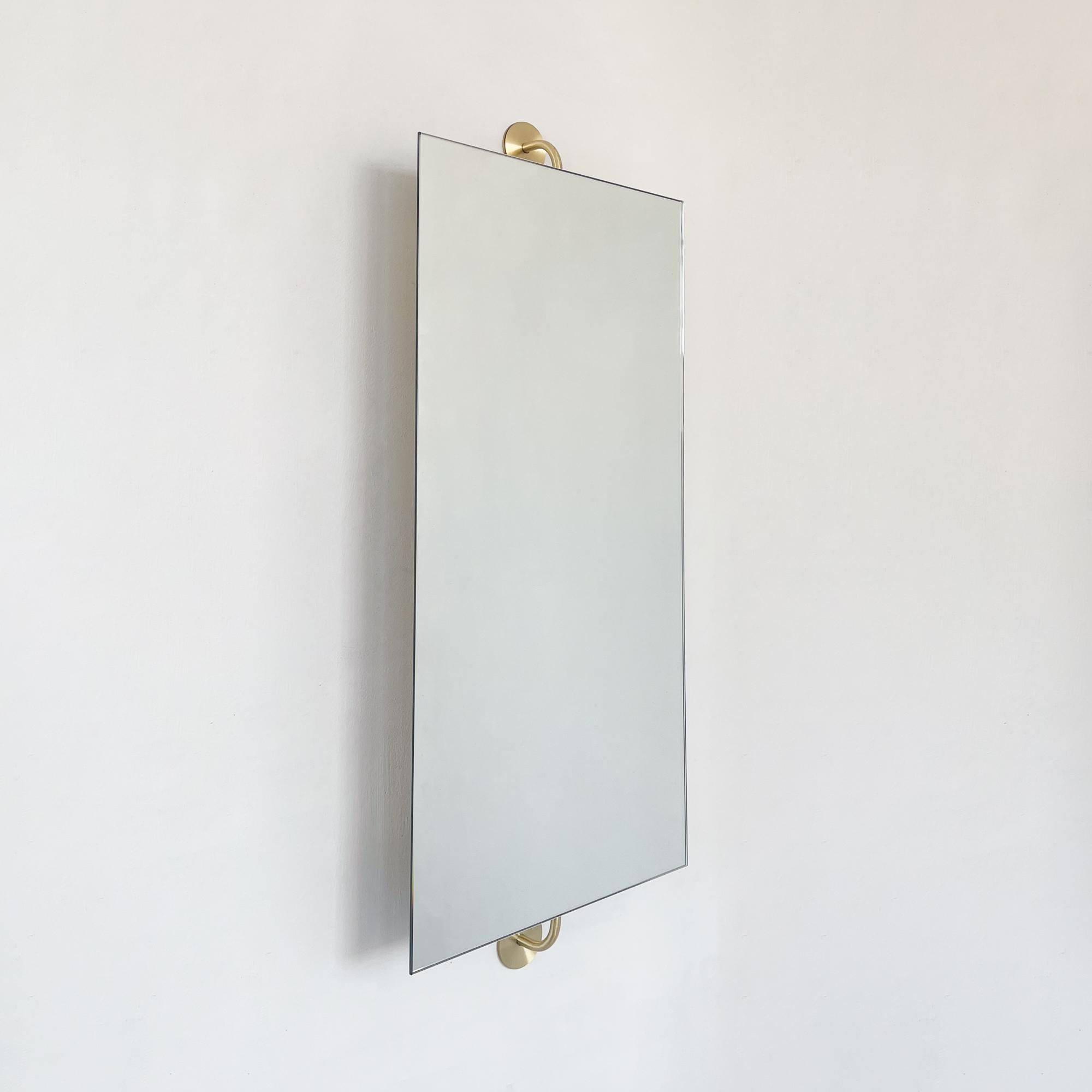 Minimalist Vorso™ rectangular rotating frameless mirror with an elegant handcrafted solid brushed brass backing. Designed and handcrafted in London, UK. This mirror is fully customisable to suit the specific requirements of your interior.

The two