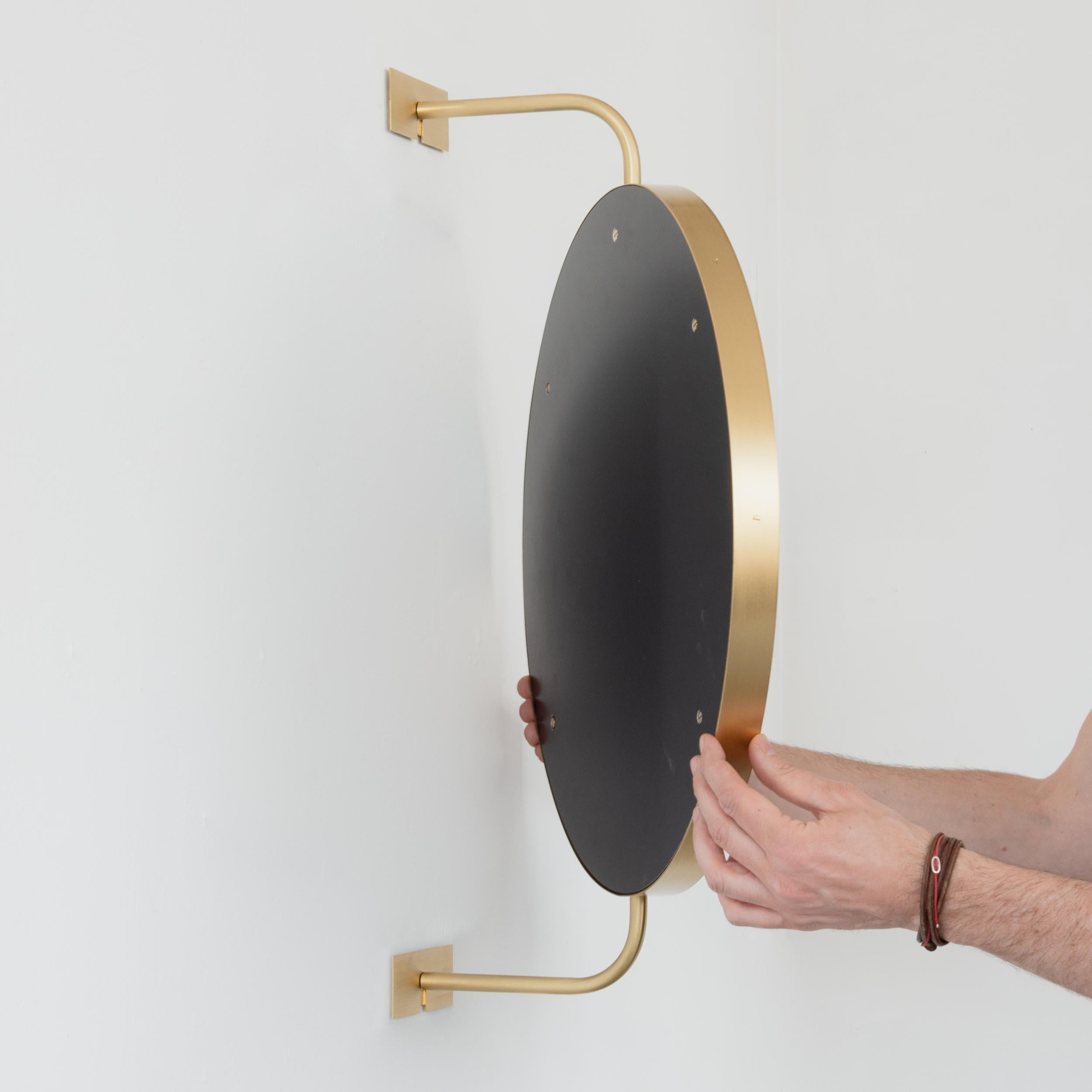 British Vorso Wall Attached Suspended Rotating Round Mirror with Brushed Brass Frame For Sale