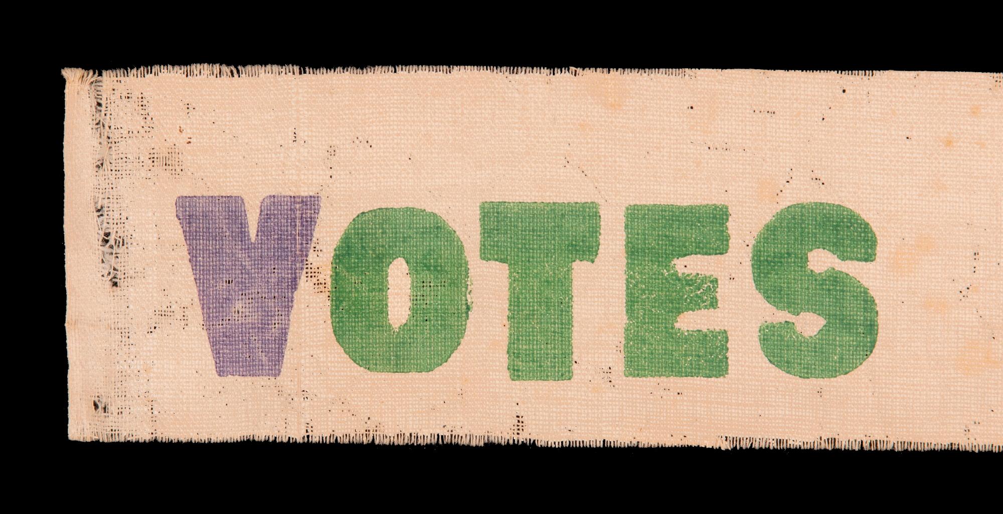 VOTES FOR WOMEN PARADE TEXTILE IN PURPLE AND GREEN, OF A TYPE WORN AS SASHES AND WAVED AS NARROW PARADE BANNERS, MADE IN HARTFORD, CONNECTICUT BY CALHOUN PRESS FOR THE WOMEN'S POLITICAL UNION OF NEW YORK, CONNECTICUT, AND NEW JERSEY, ORGANIZED BY