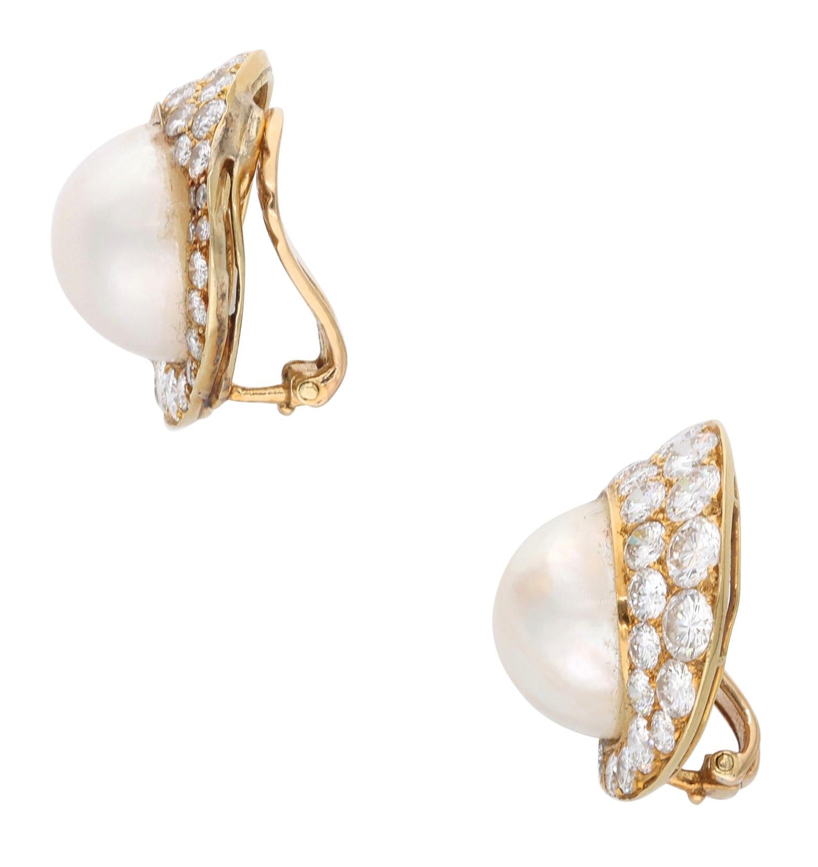 These ear clips are composed of mabé pearls and round brilliant cut diamonds.

- Mabé pearls measure approximately 14mm
- Diamonds weigh a total of approximately 6.00 carats
- Signed Vourakis
- 18 karat yellow gold
- Total weight 16 grams
- Length 1